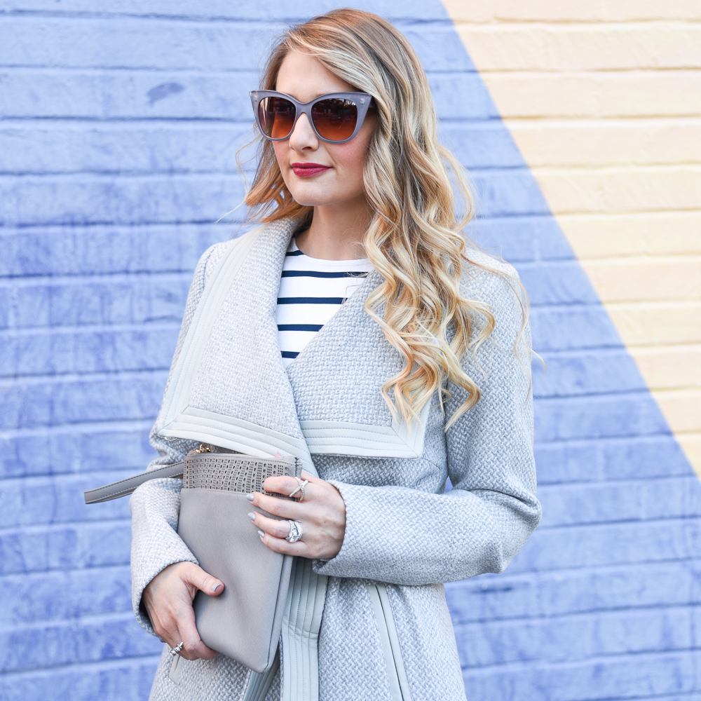 Jenna Colgrove wearing Grey cat eye sunnies and a grey wrap coat that is perfect for fall.