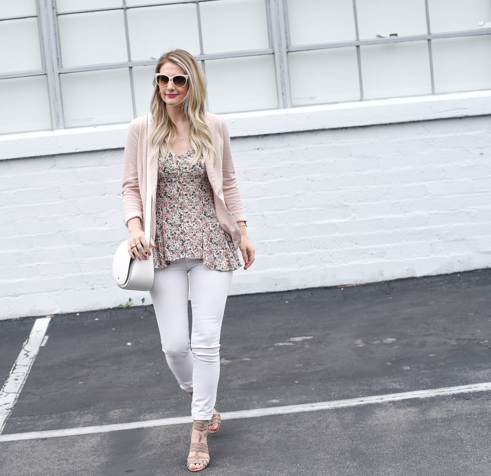 Jenna Colgrove wearing rose quartz and white skinny jeans with a strappy sandal. 