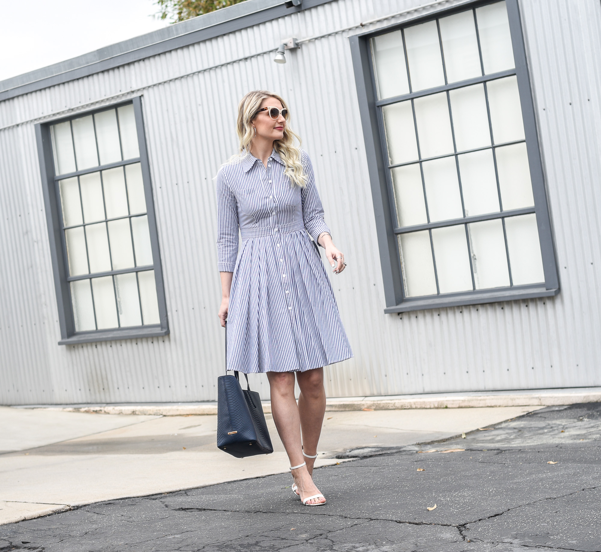 @jennacolgrove in a button front striped dress with pleated skirt. 