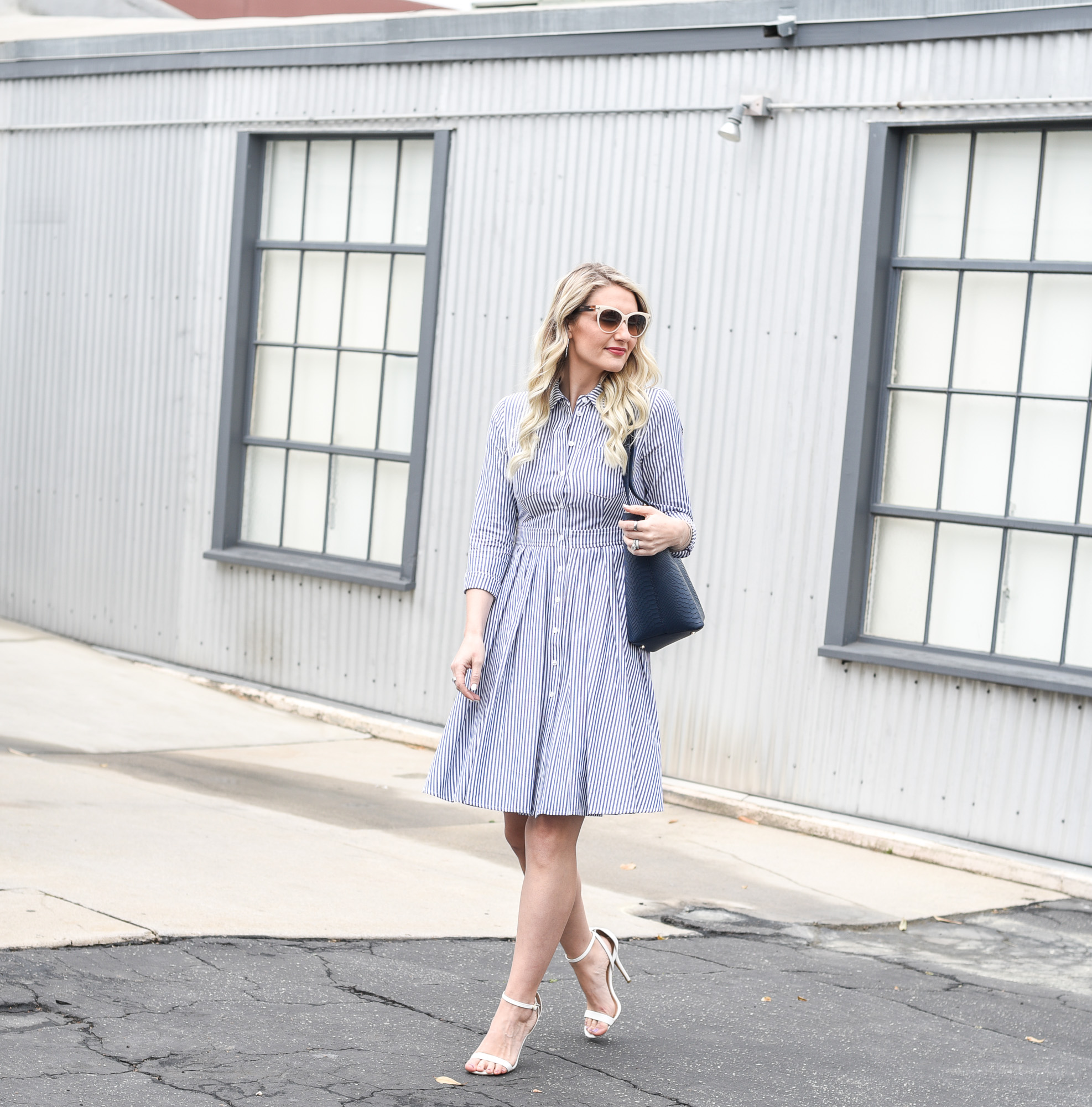 Jenna Colgrove wearing a striped fit and flare dress that is great for spring. 