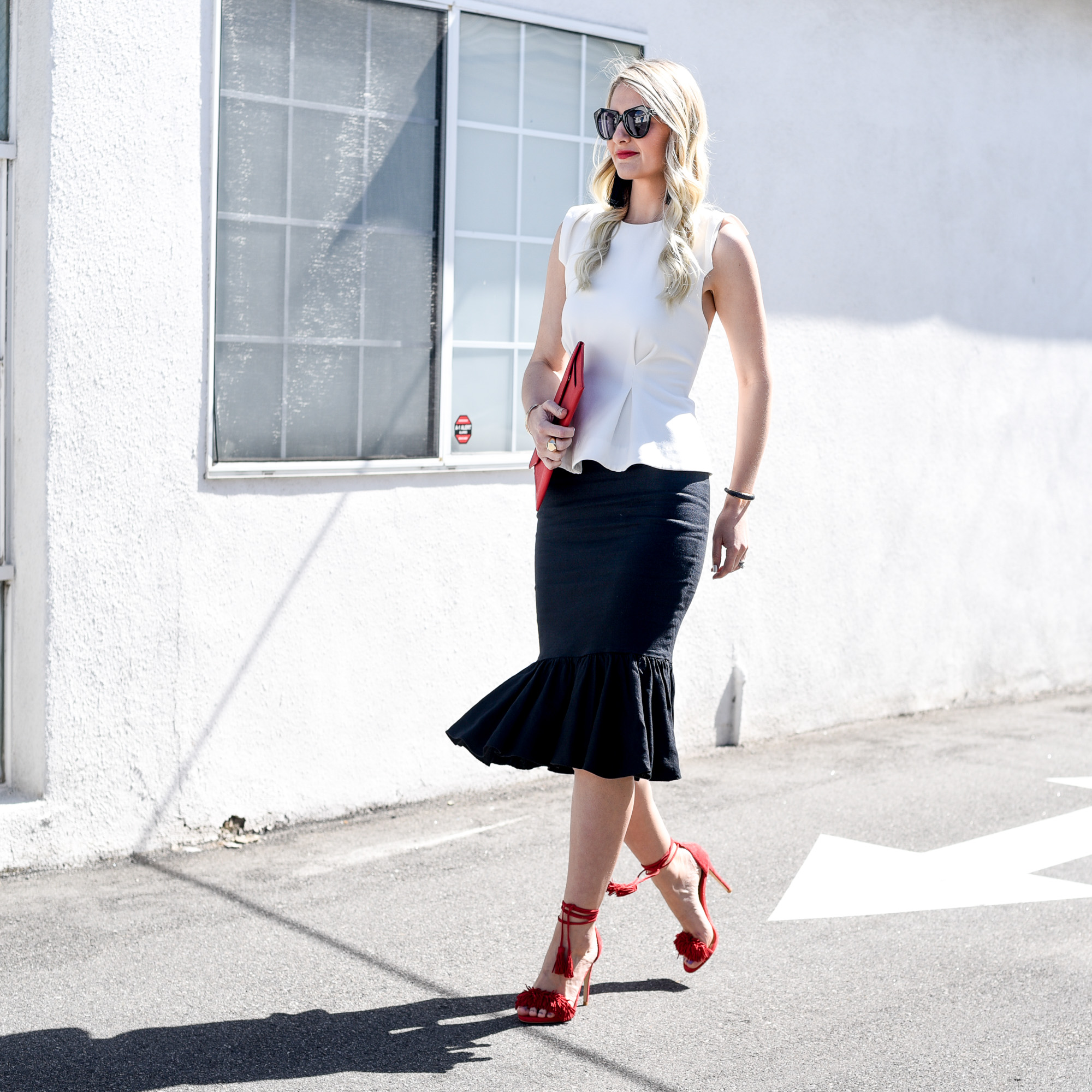 Basic black and white with pops of red fringe and an envelop clutch. 