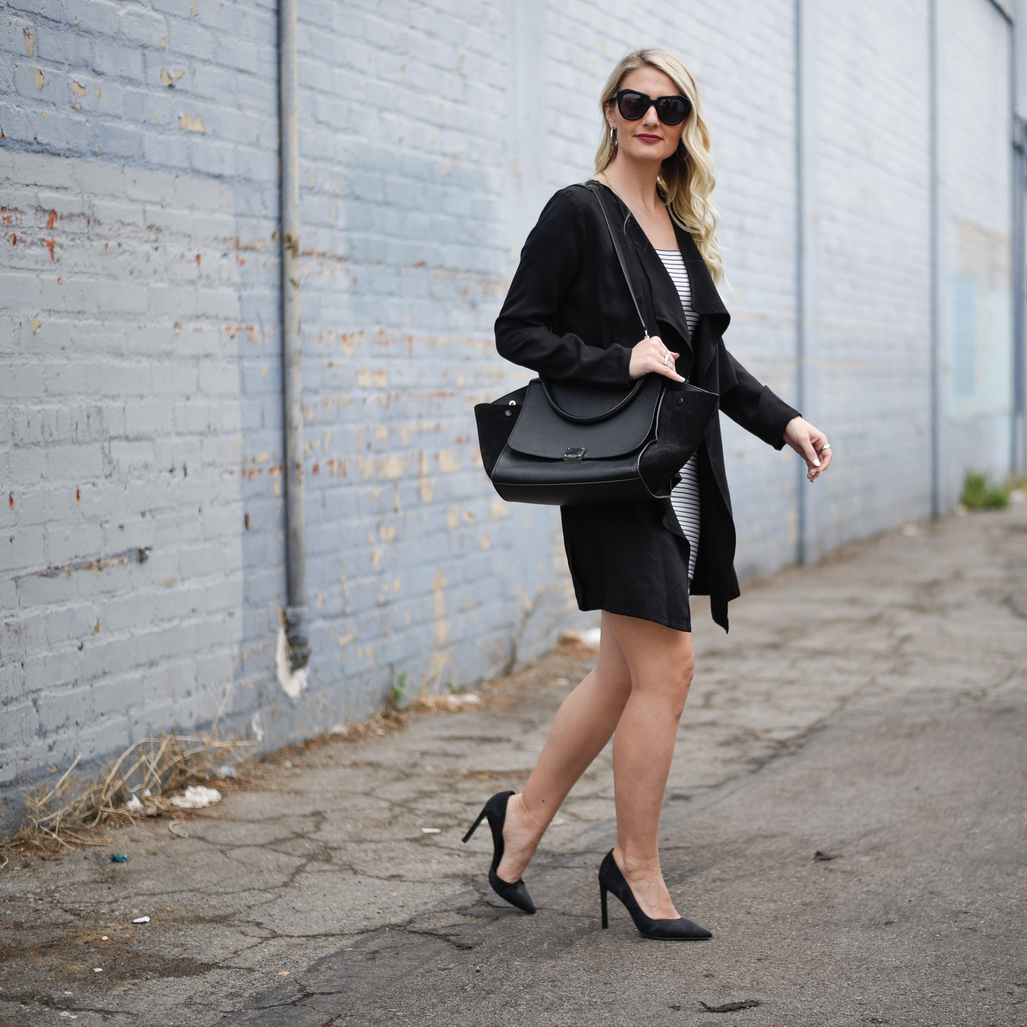 Pair a flowy black coat with your short dress for a balanced look.