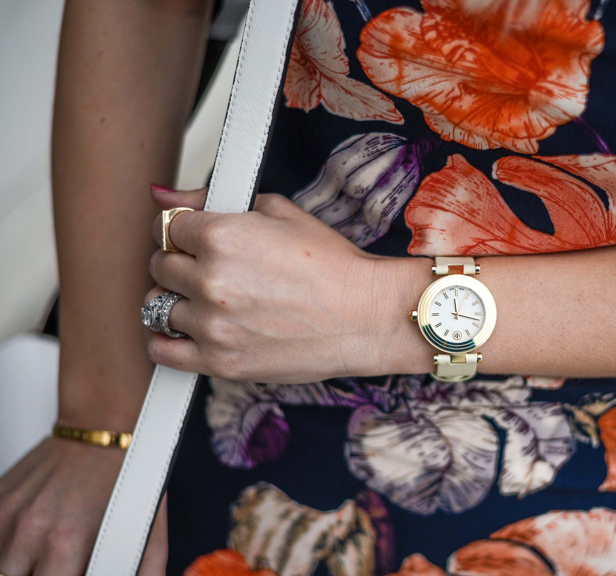 White leather watch with a gold face. 