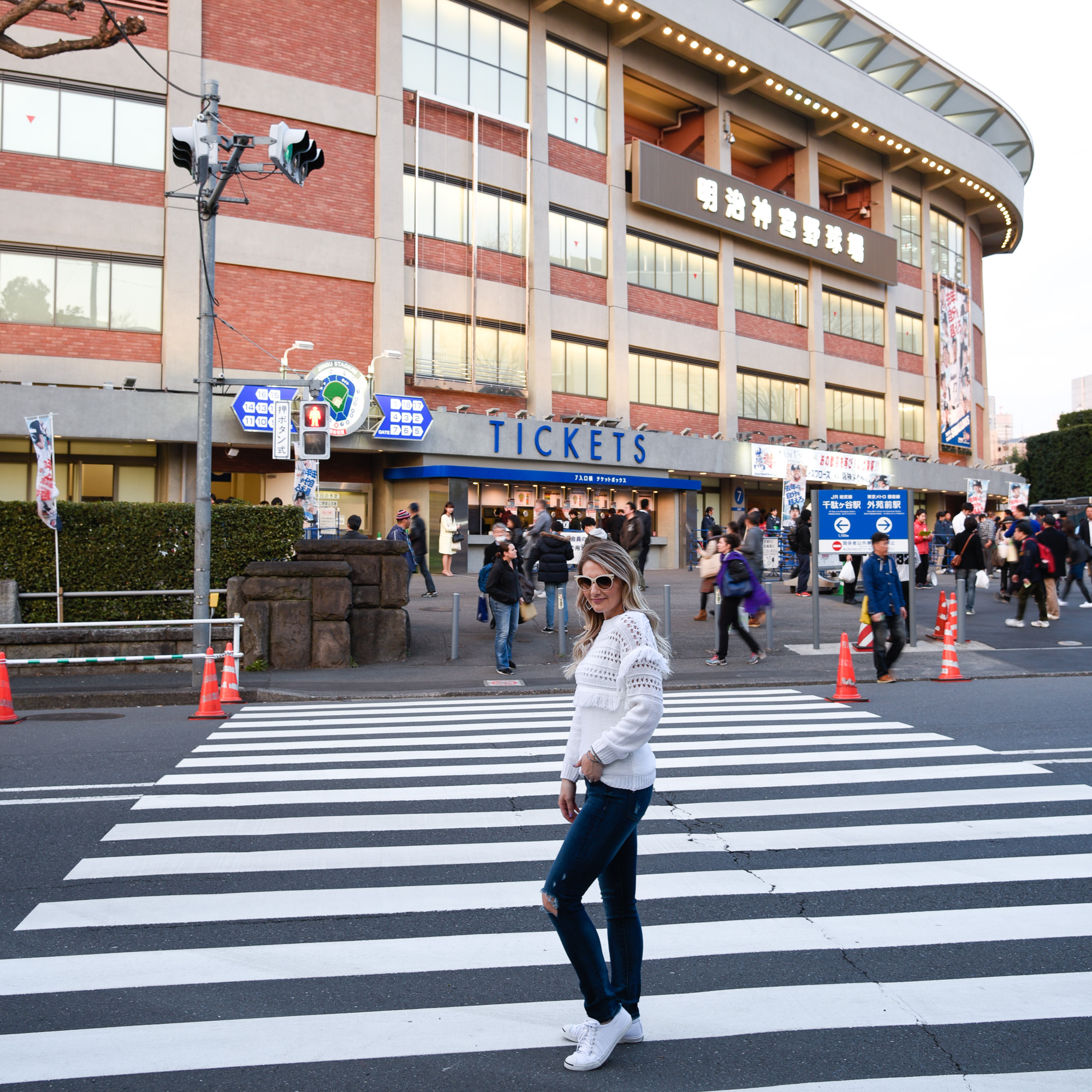 A baseball game in Tokyo in a fringe sweater and ripped skinny jeans. 