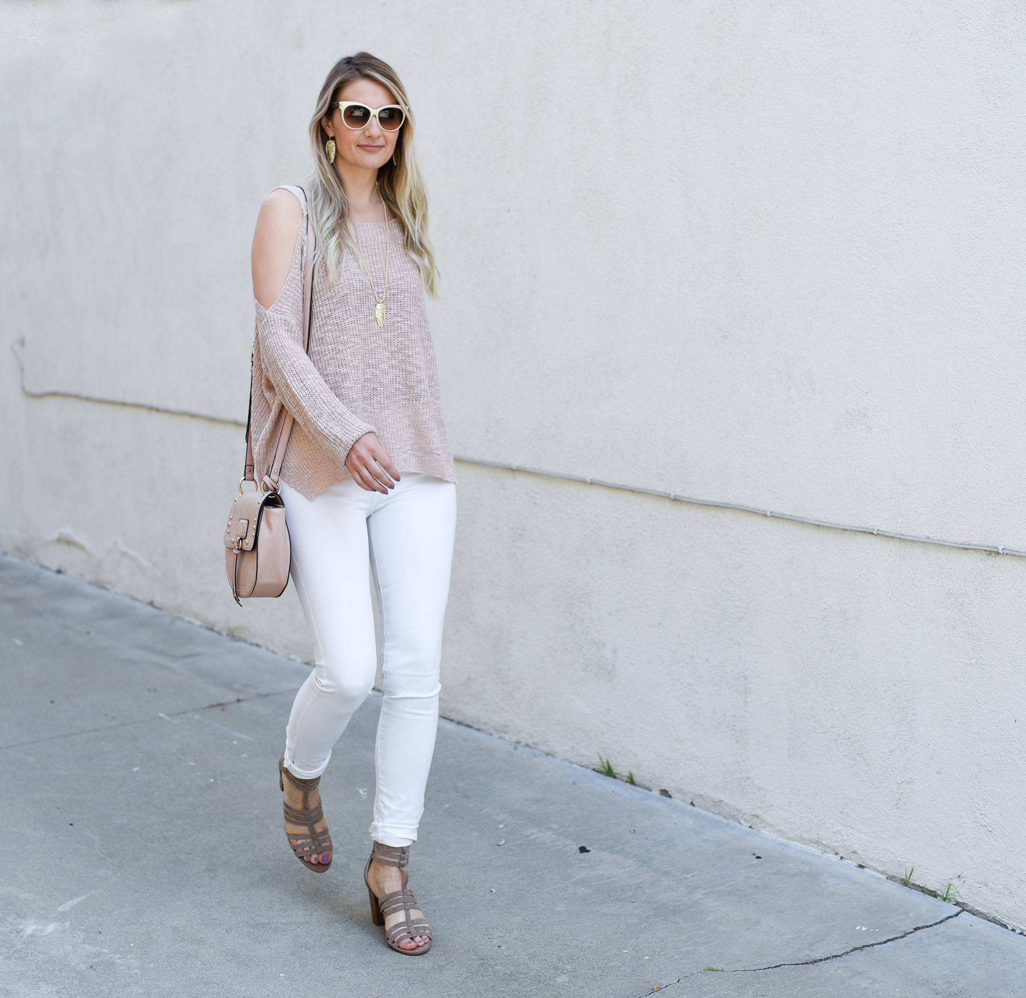 Jenna Colgrove in a blush cold shoulder sweater and white skinny jeans. 