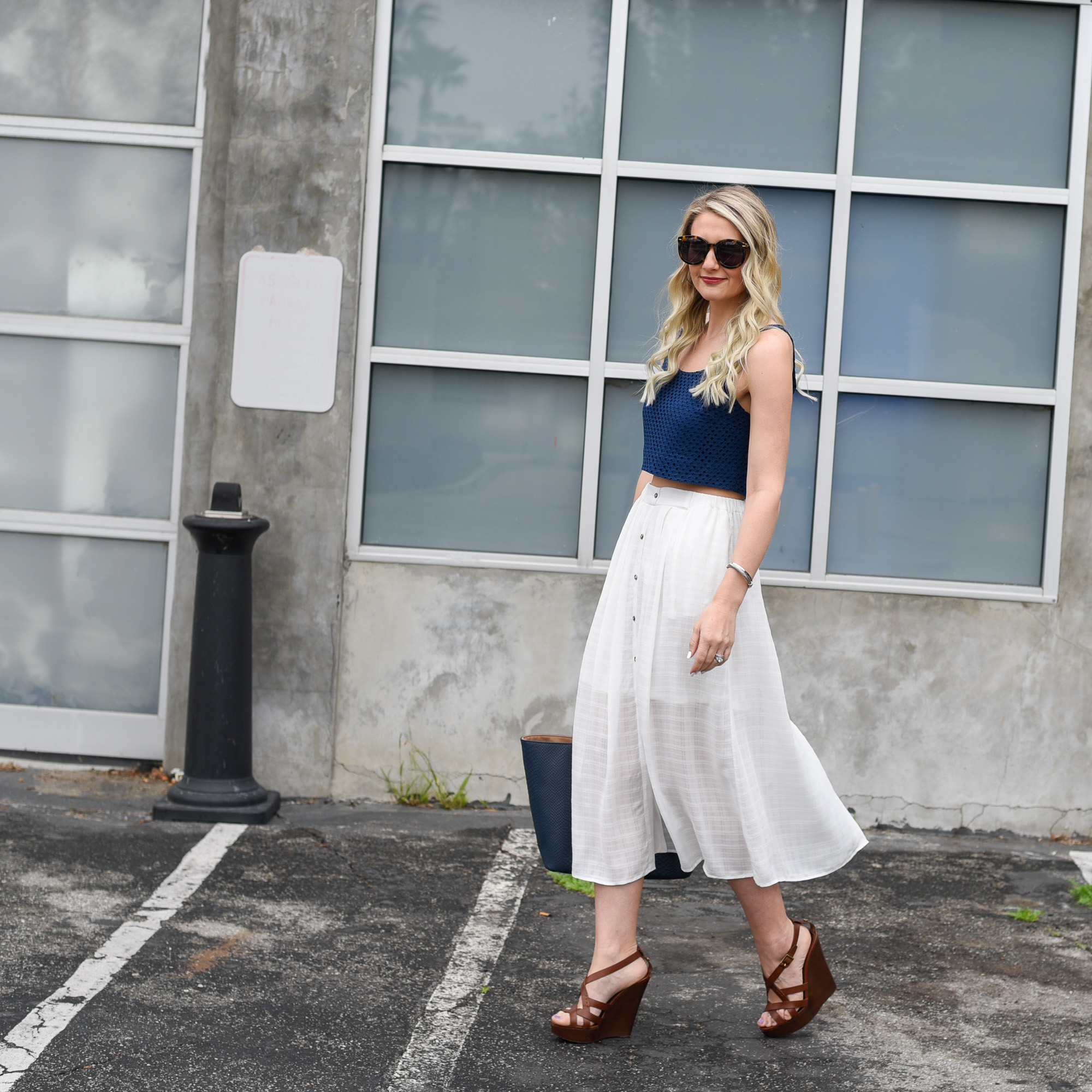 A blue tank top crop with eyelet print and a flowy skirt.