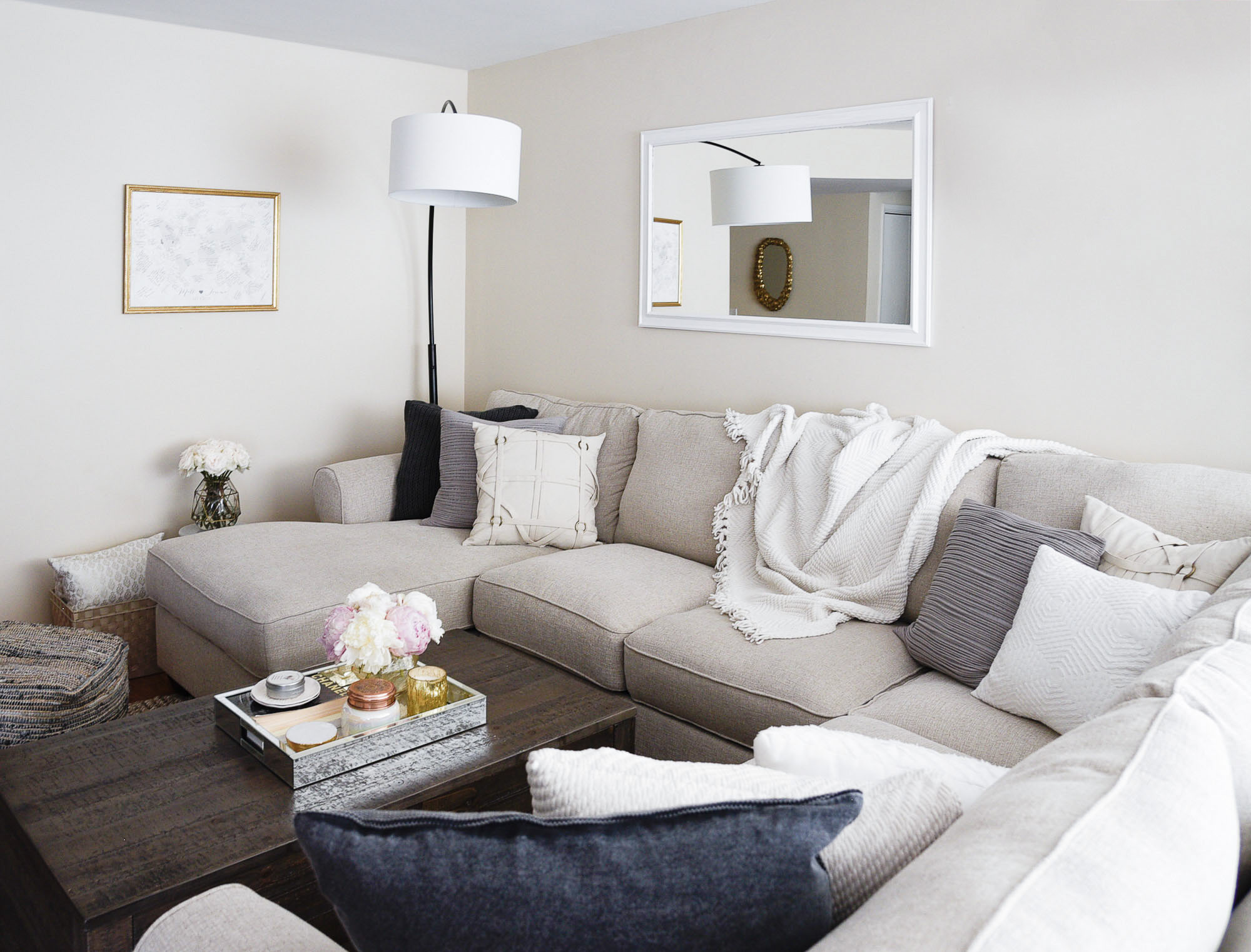 a white sofa with black and grey accent pieces 