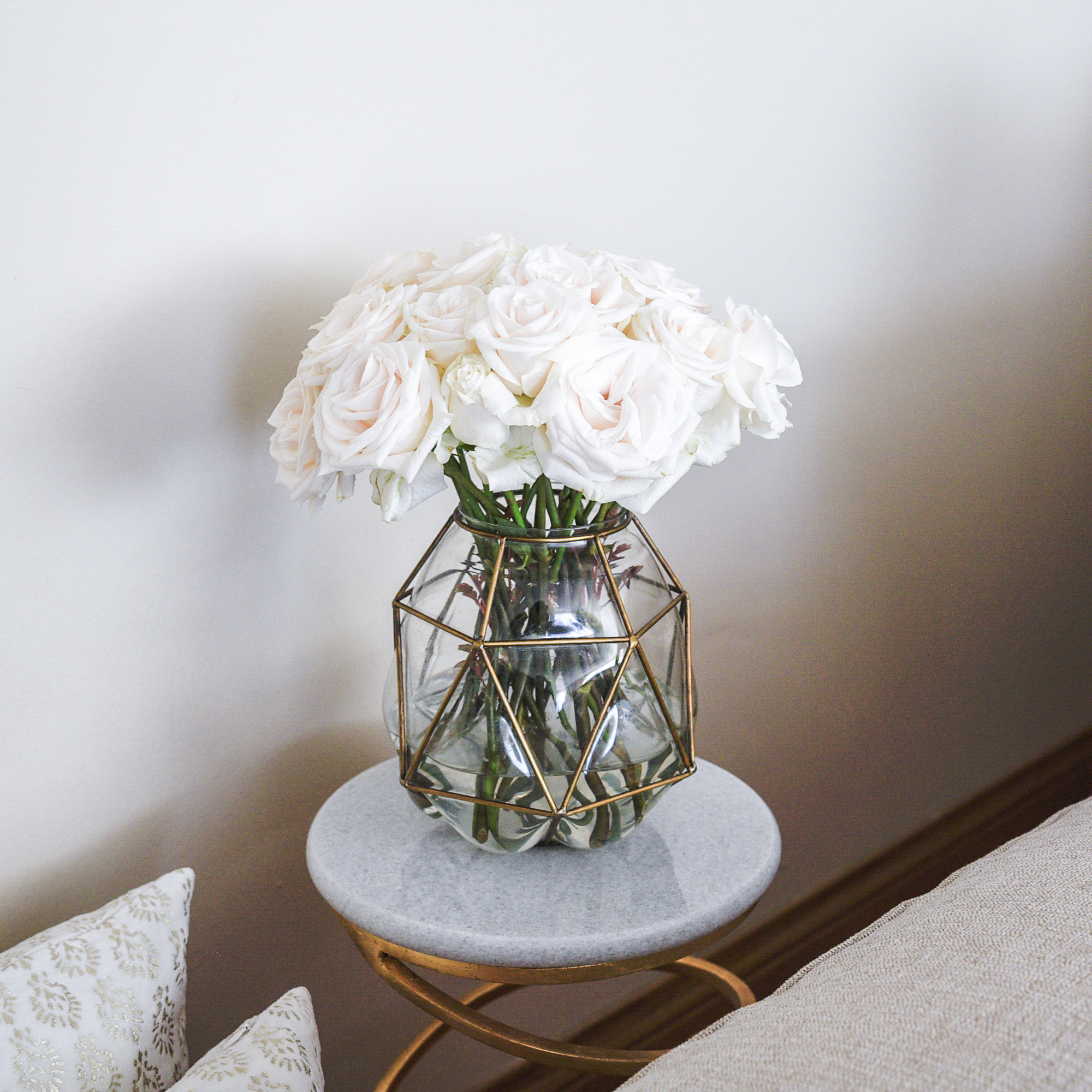 white roses in a brass vase 