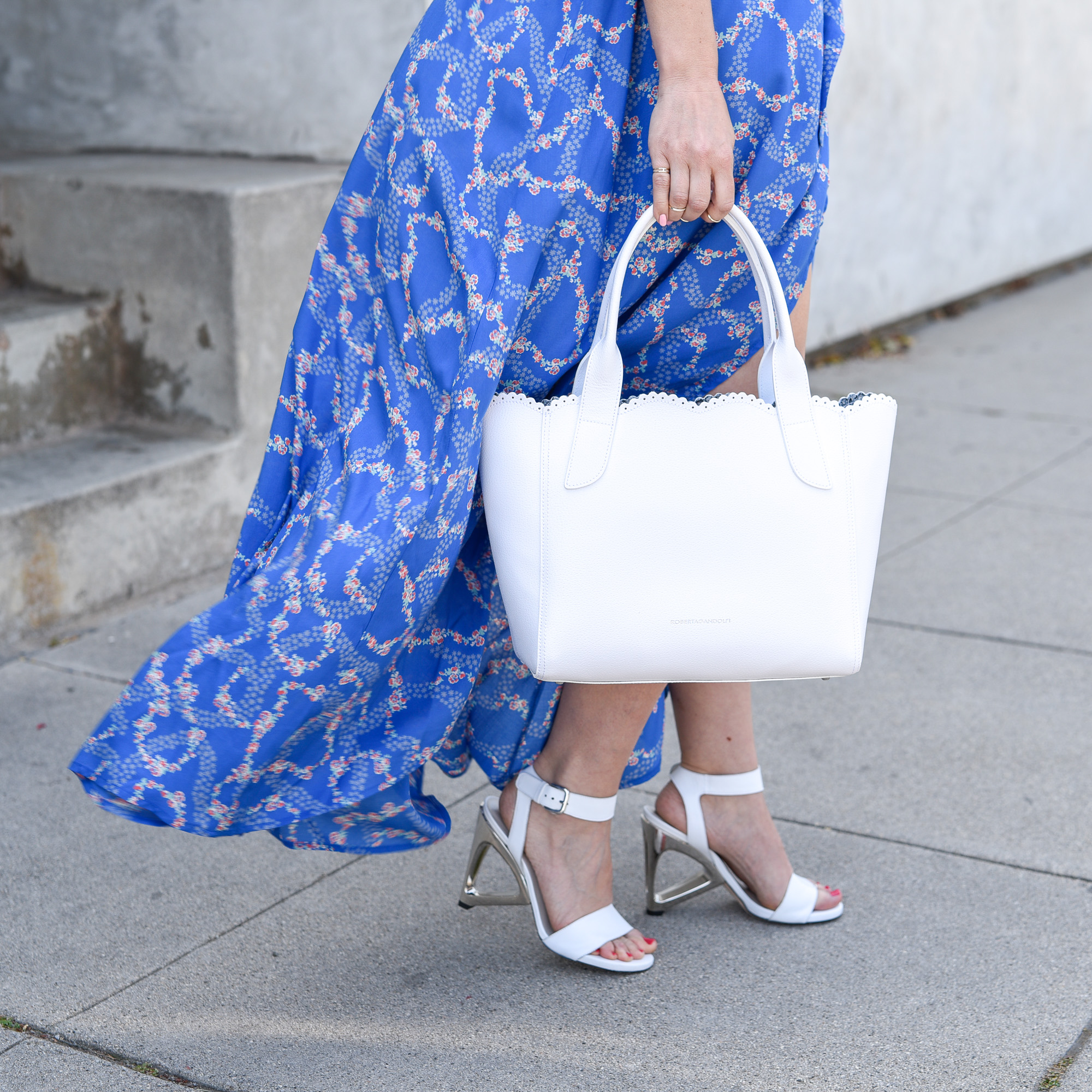 White heels with metallic accents and a matching purse. 