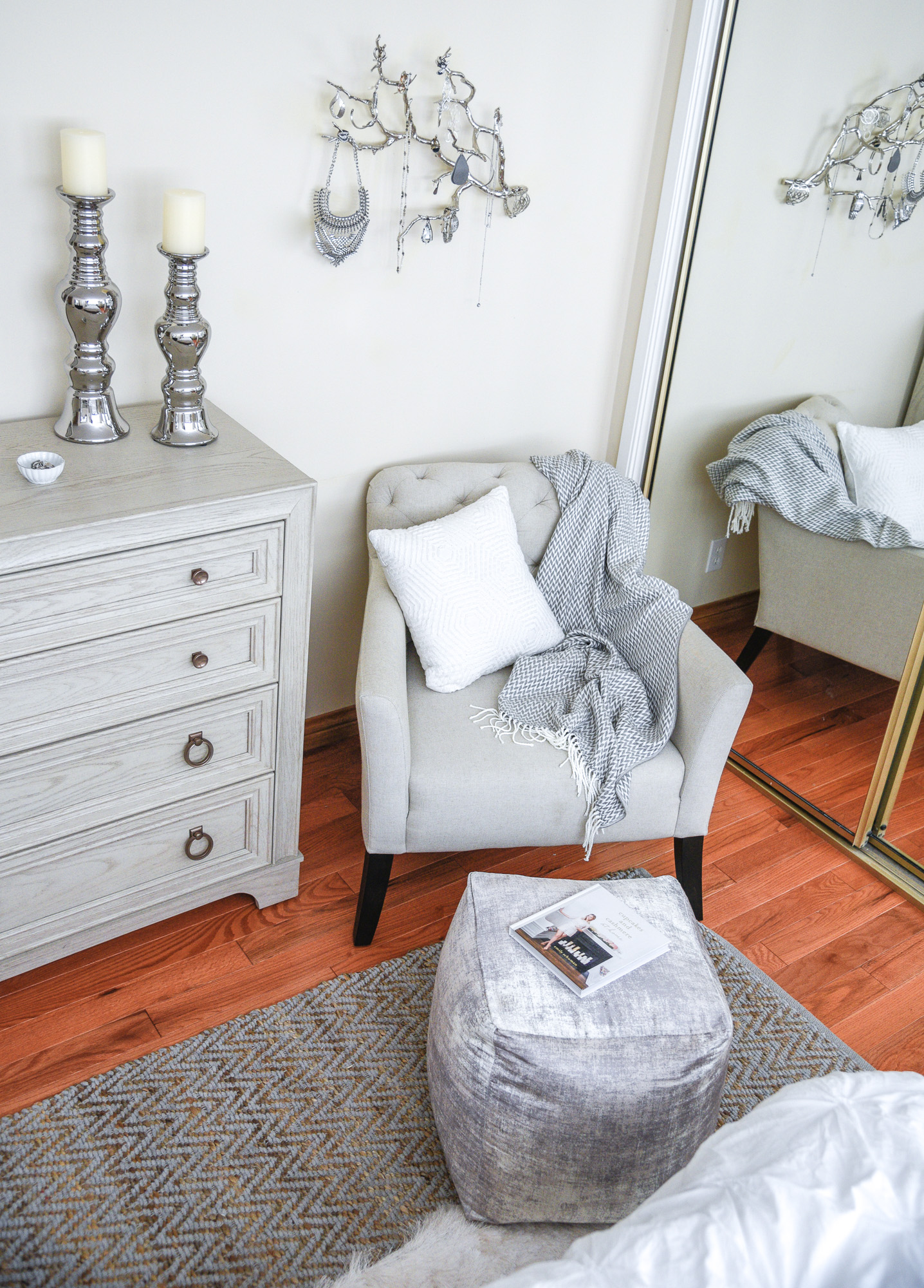 white frayed pillow with a plush pouf in silver 