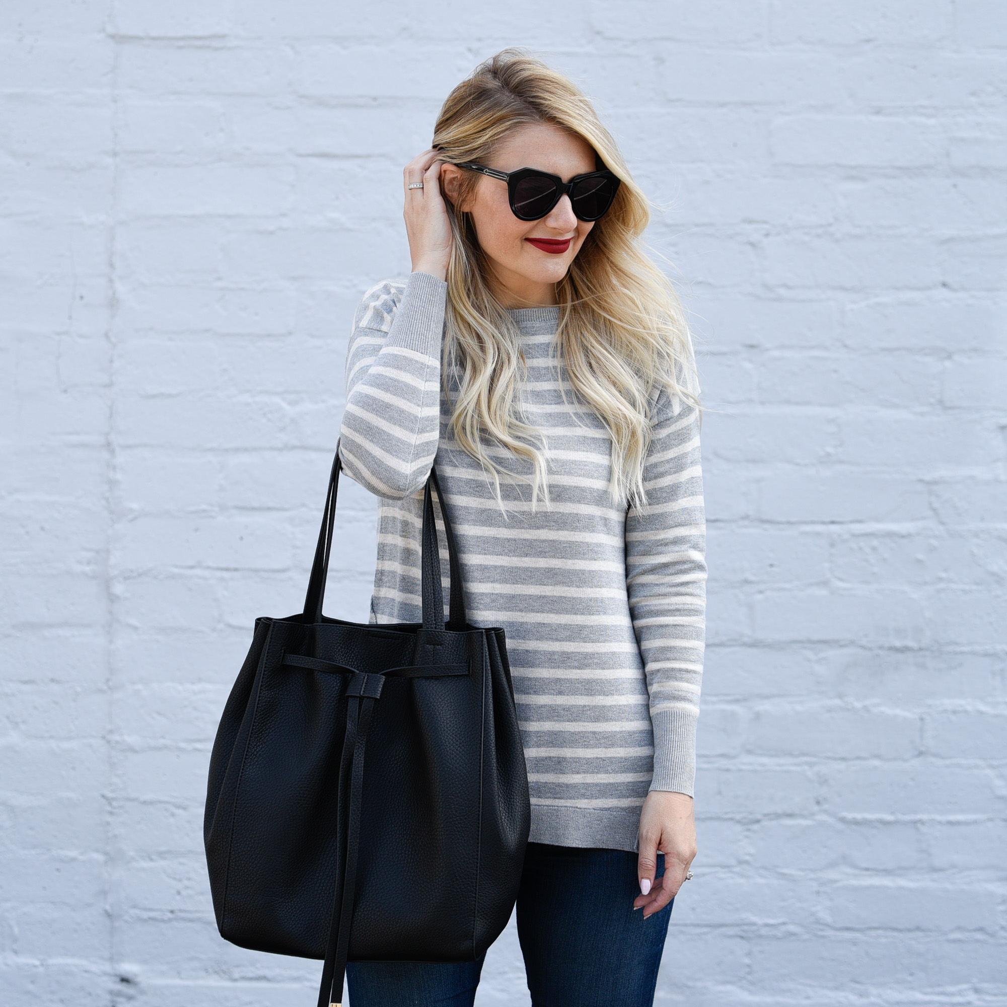 Grey striped sweater with zip up back.