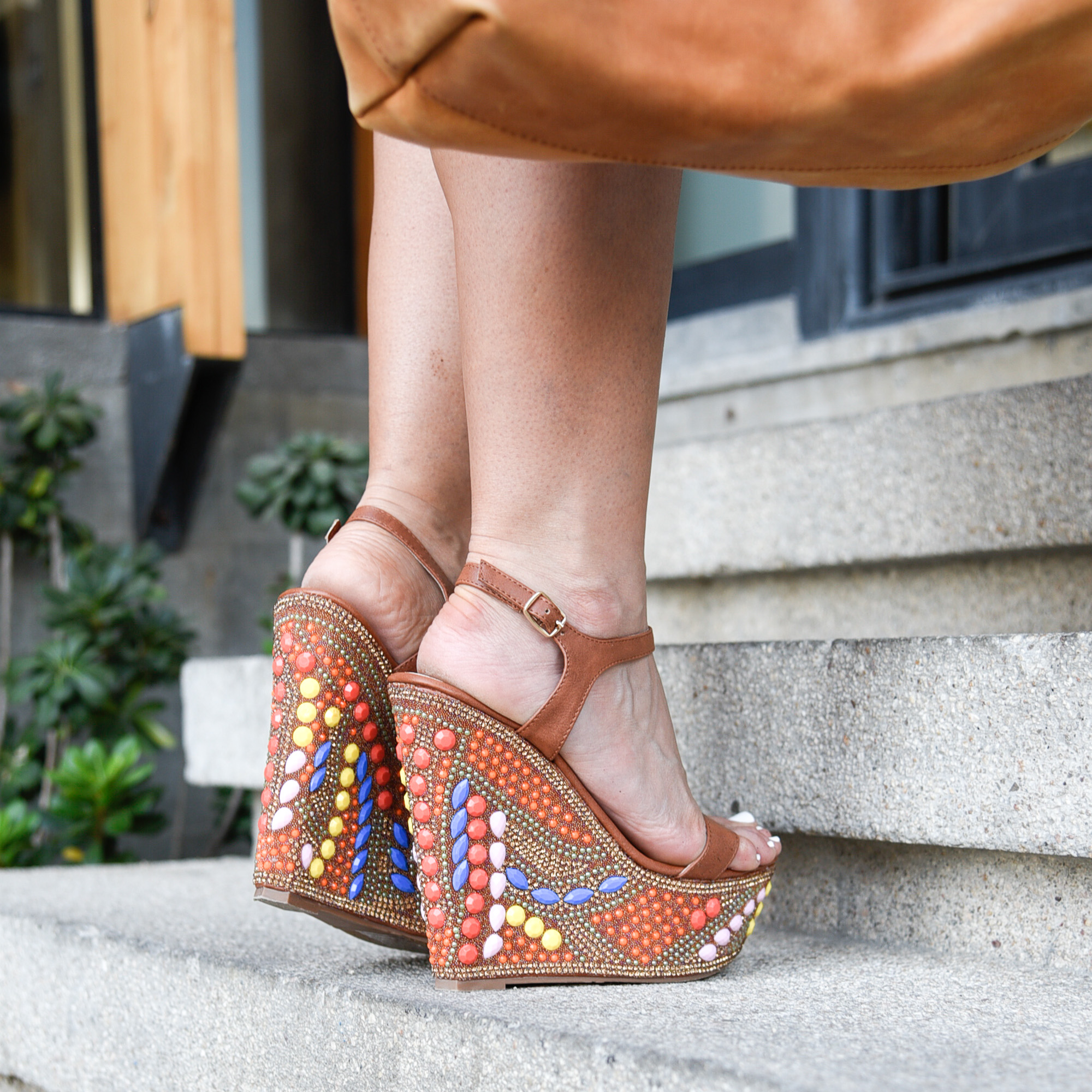 Beaded and studded brown cognac wedges.