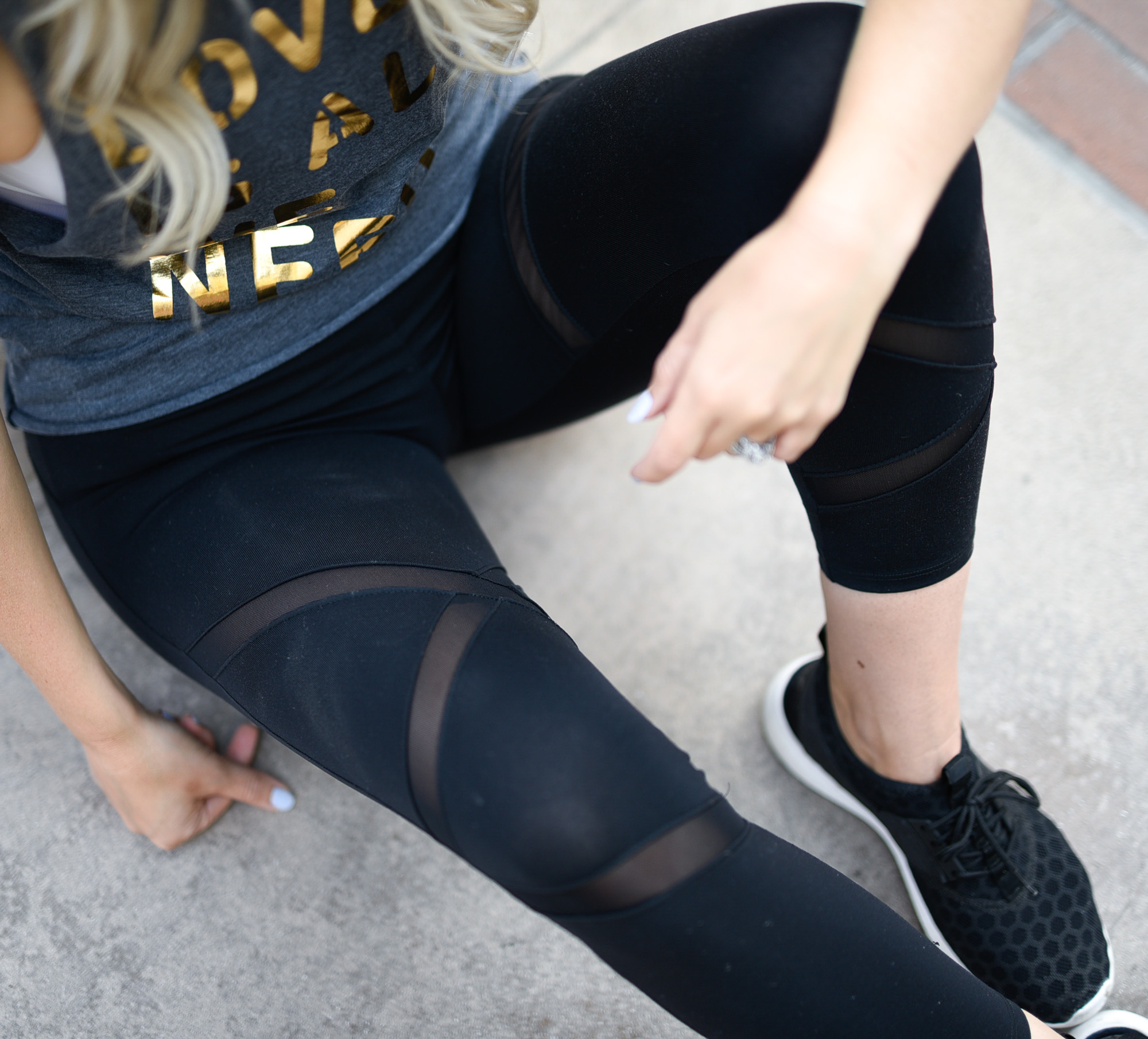 Black workout leggings with mesh inserts.