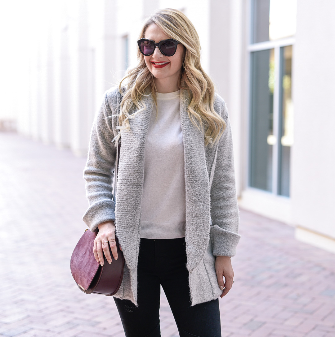 Jenna Colgrove wearing a cozy grey sweater with pockets. 