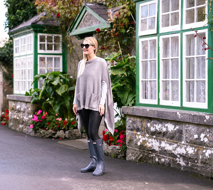 Jenna Colgrove in the Anthropologie Madison Park Poncho in grey on the grounds of Ashford Castle. 