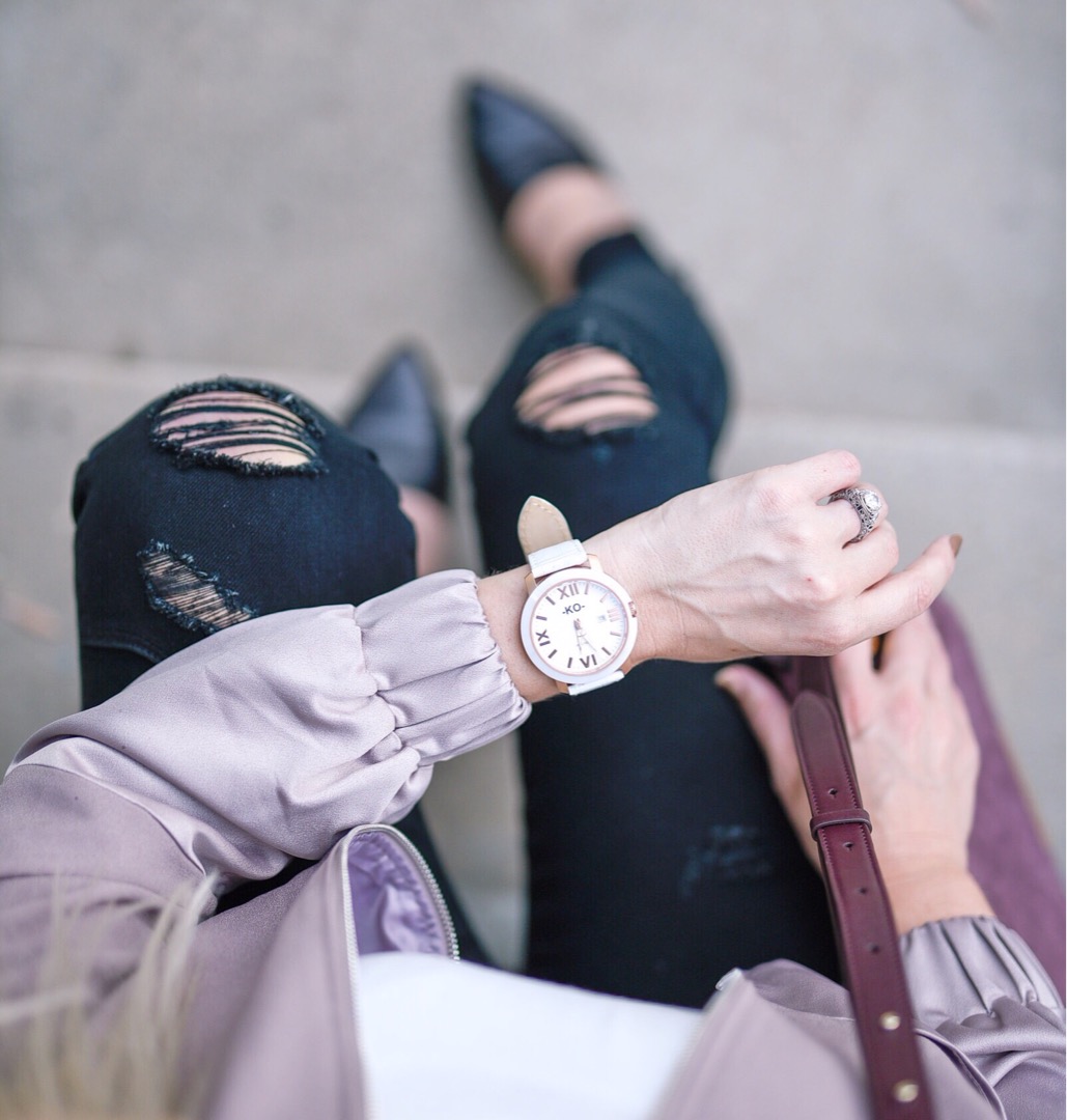 White and rose gold KO Watch with a blush bomber and distressed black skinny jeans. 