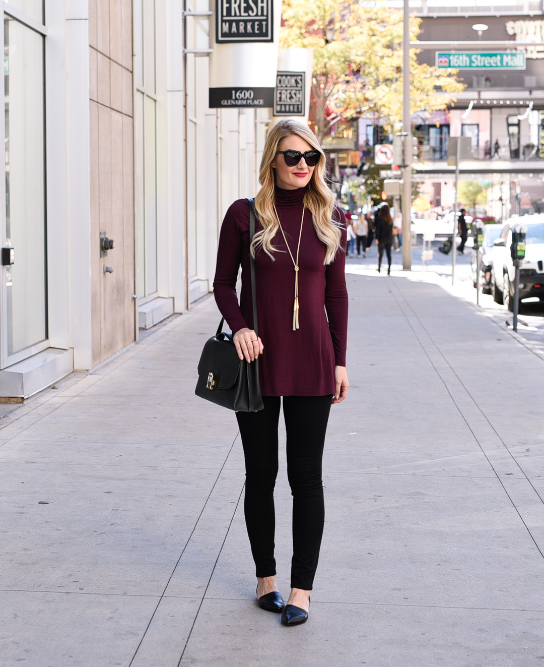 Jenna Colgrove wearing a Dex Turtleneck Tunic and black skinny jeans. 