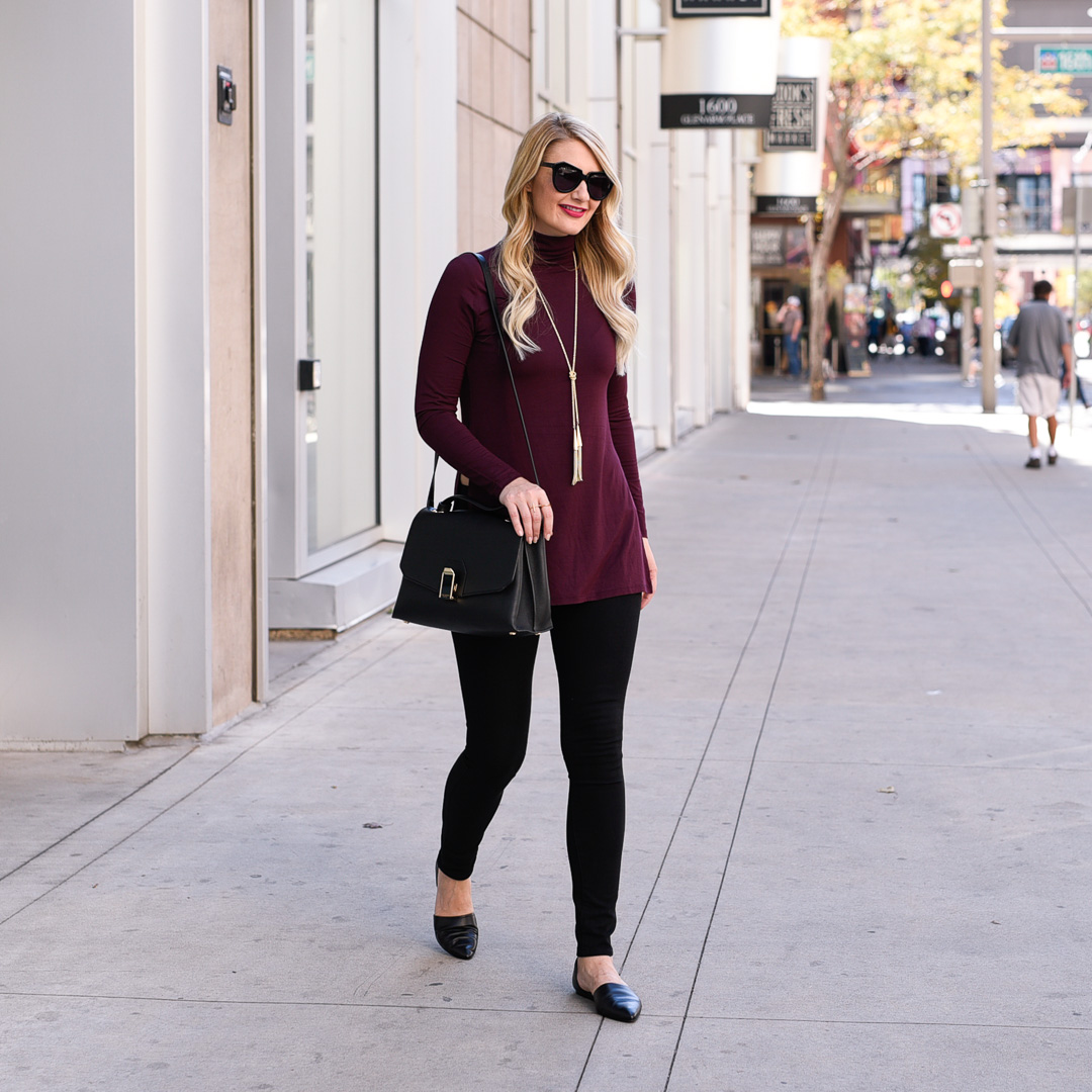 Visions of Vogue wearing a burgundy Dex turtleneck and stretchy black jeans. 