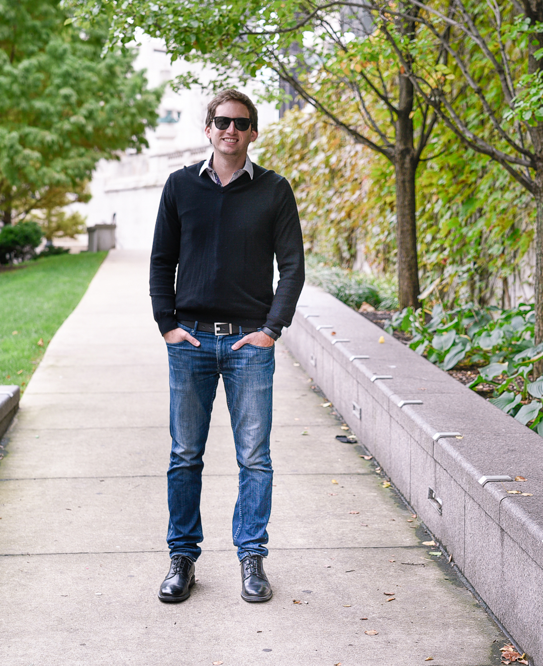 Matt Borucki of Dude's Digest wearing a black v neck sweater and Paige denim skinny jeans. 