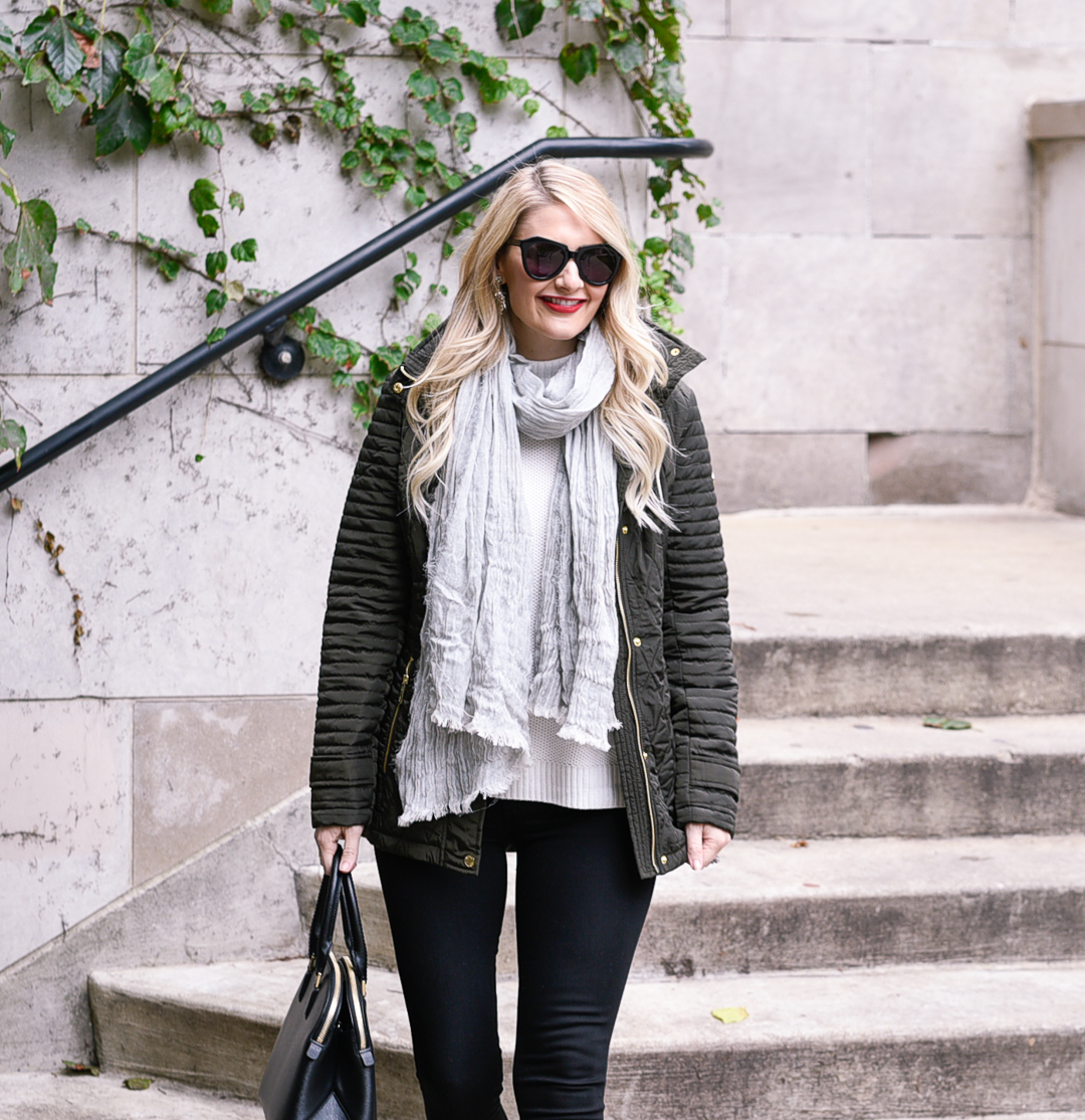 Jenna Colgrove wearing a quilted Michael Kors green jacket, Black skinny jeans, and a grey linen scarf. 