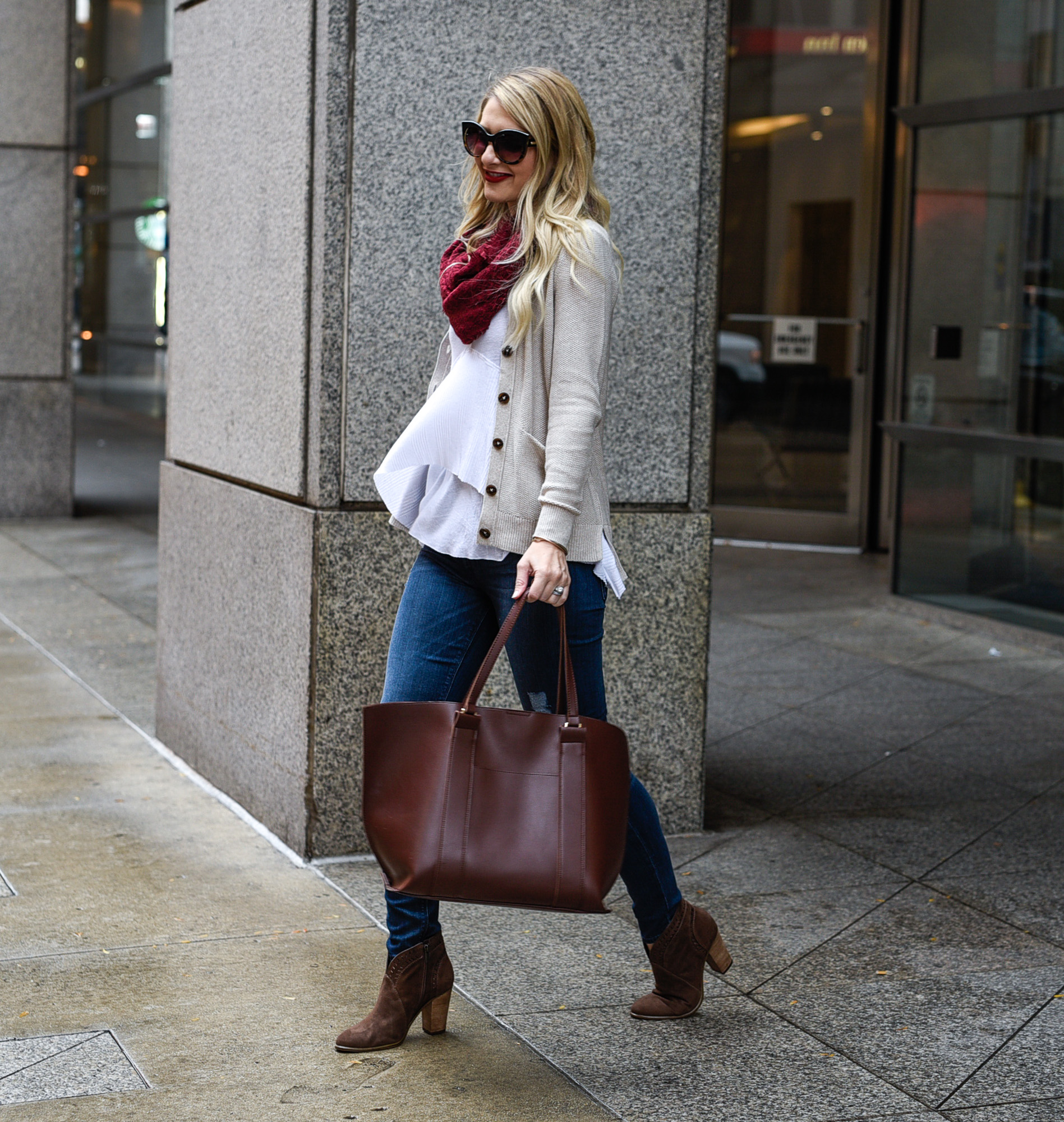 Jenna Colgrove wearing a Free People white t shirt, an infinity scarf, and Vince Camuto booties. 