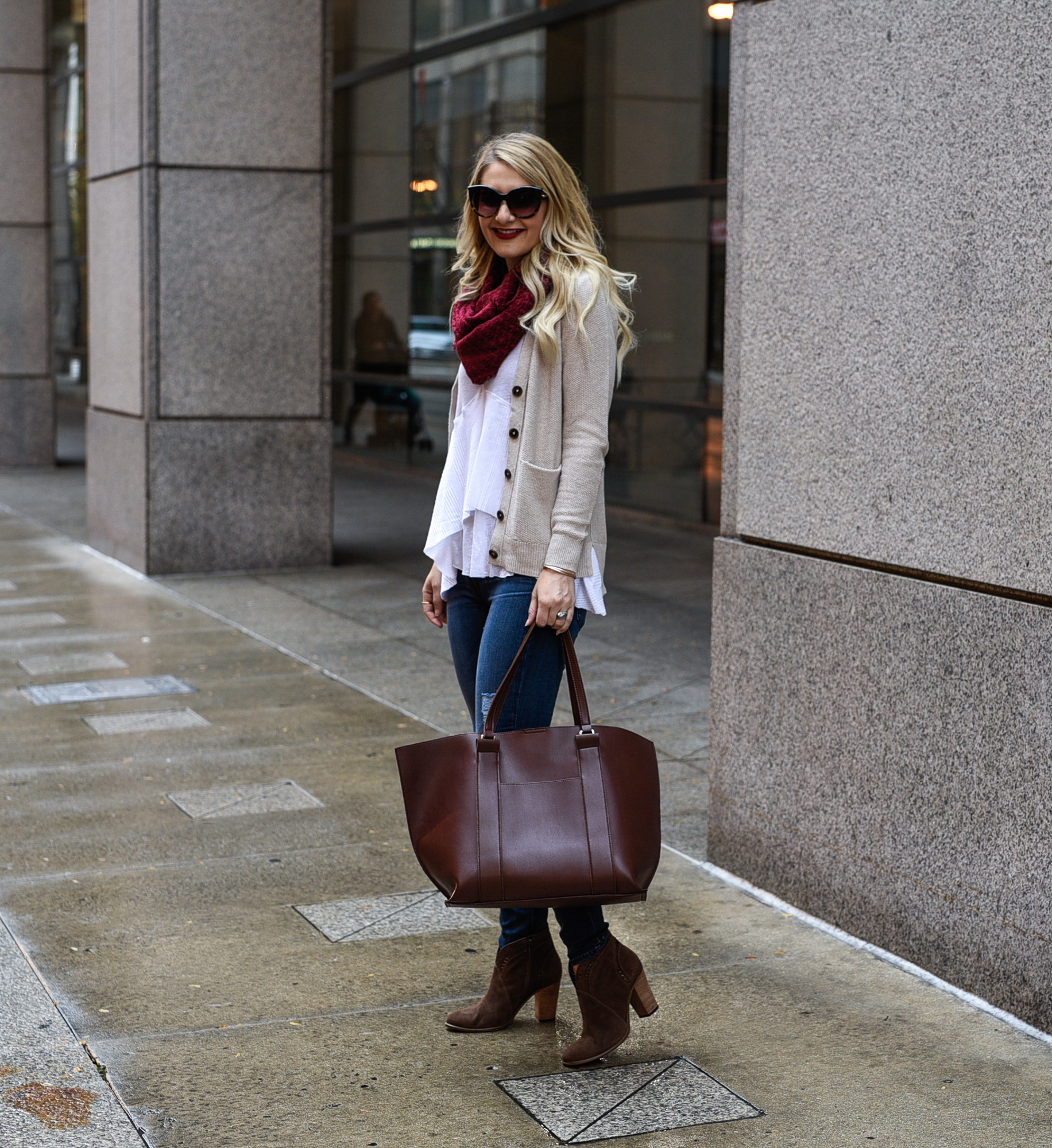 Jenna Colgrove in downtown Chicago wearing a cozy cardigan, brown handbag, and suede boots. 