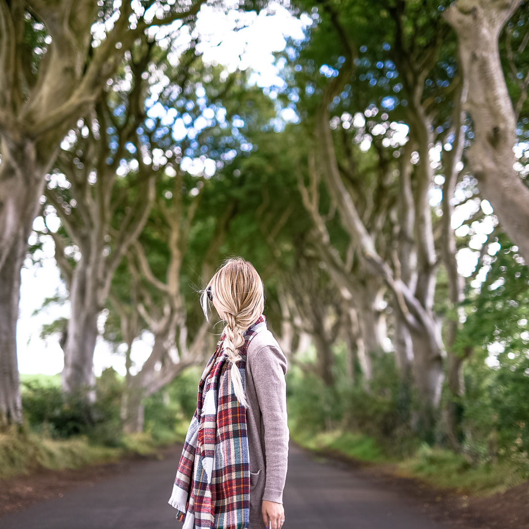 Plaid Scarf and a beige cardigan at The Dark Hedges in Northern Ireland. 