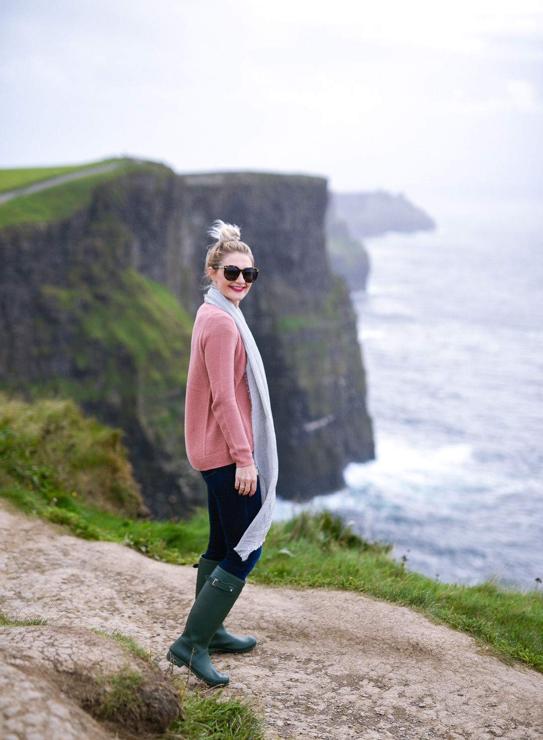 Jenna Colgrove wearing a pink Madewell sweater at the Cliffs of Moher, Ireland. 