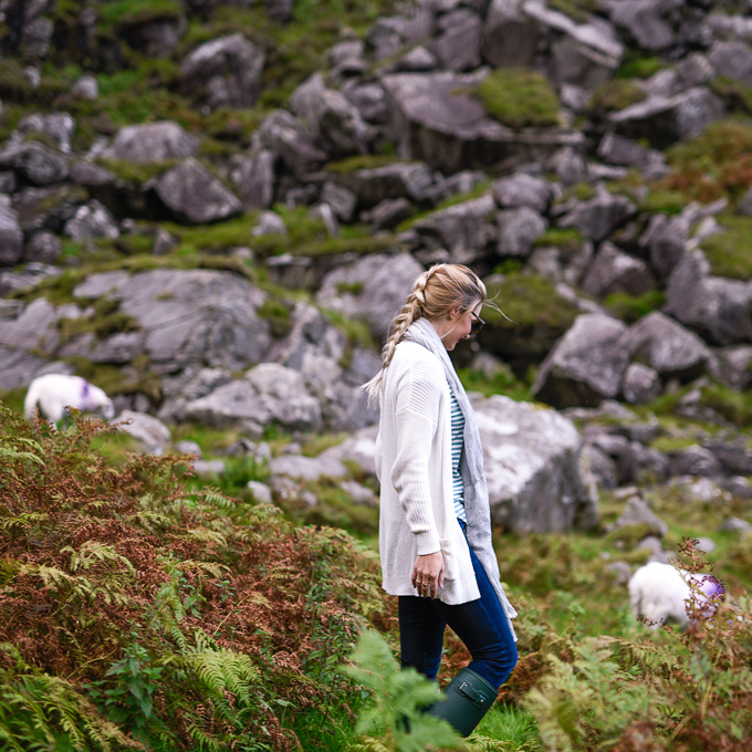 Jenna Colgrove and in a white cardigan and grey linen scarf. 