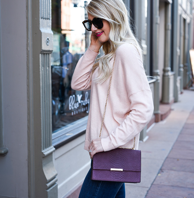 Jenna Colgrove wearing an oversized pink sweater by Leith and the Ivanka Trump Mara cocktail bag in burgundy.