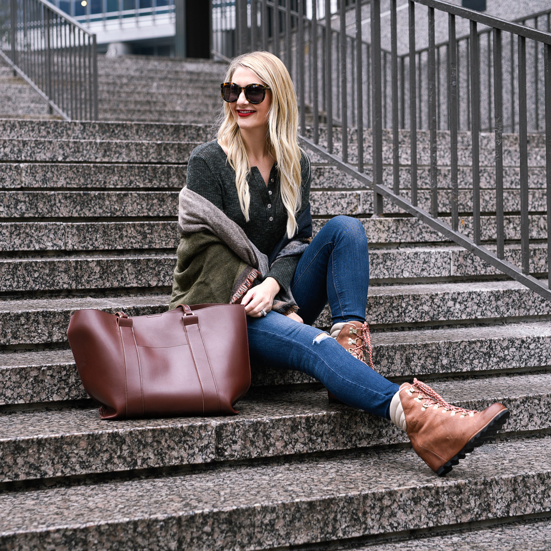 Jenna Colgrove wearing the perfect fall outfit: cozy wrap, long sleeved tee, and waterproof wedges. 