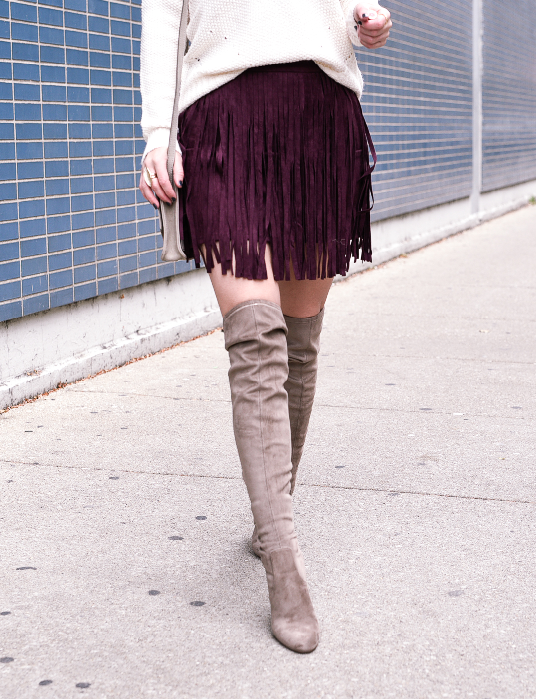 Taupe suede over the knee (otk) boots and a burgundy mini skirt with fringe detail! 