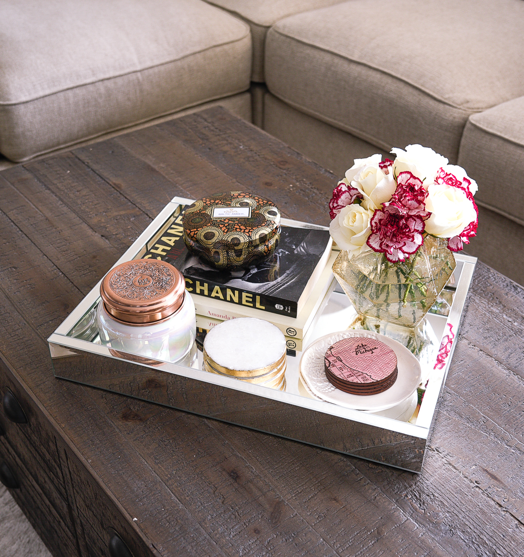 Anthropologie Volcano candles, West Elm marble and gold coasters, and an Anthropologie faceted vase make the perfect coffee table decor. 