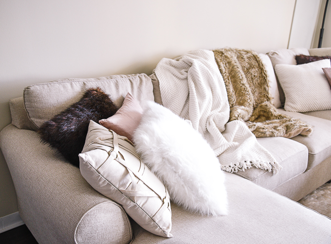 Mixing decorative pillows for a fun, cozy look in a fall living room. 