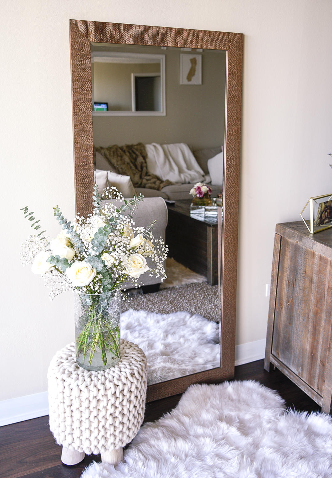 Homegoods floor length mirror and a faux fur shag run with a beautiful rose and eucalyptus bouquet. 