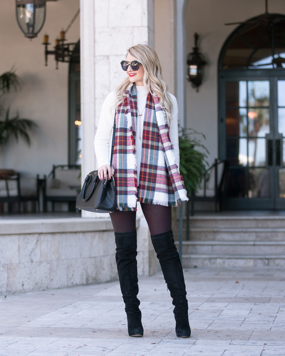 Jenna Colgrove from Visions of Vogue in a plaid blanket scarf, wine colored leggings, and black suede boots. 