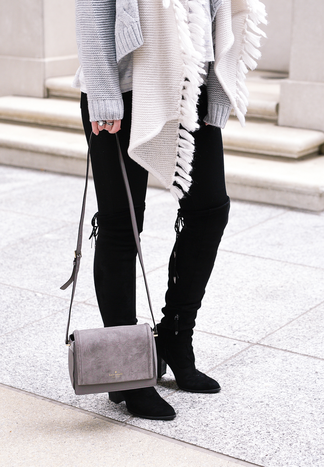 Black over the knee boots and a grey suede bag. 