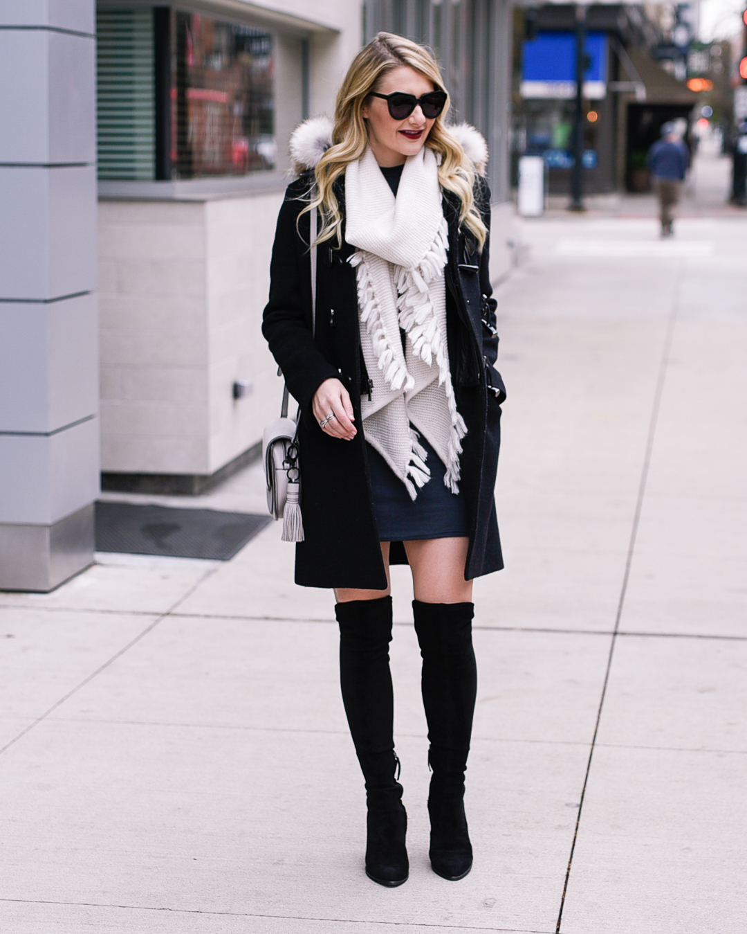 Black Parka with faux fur hood and suede over the knee boots. 
