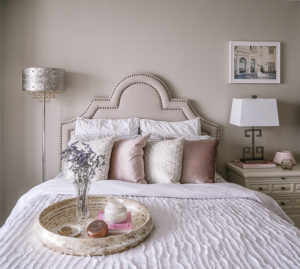 A second guest bedroom decorated in pink, gold, and white.