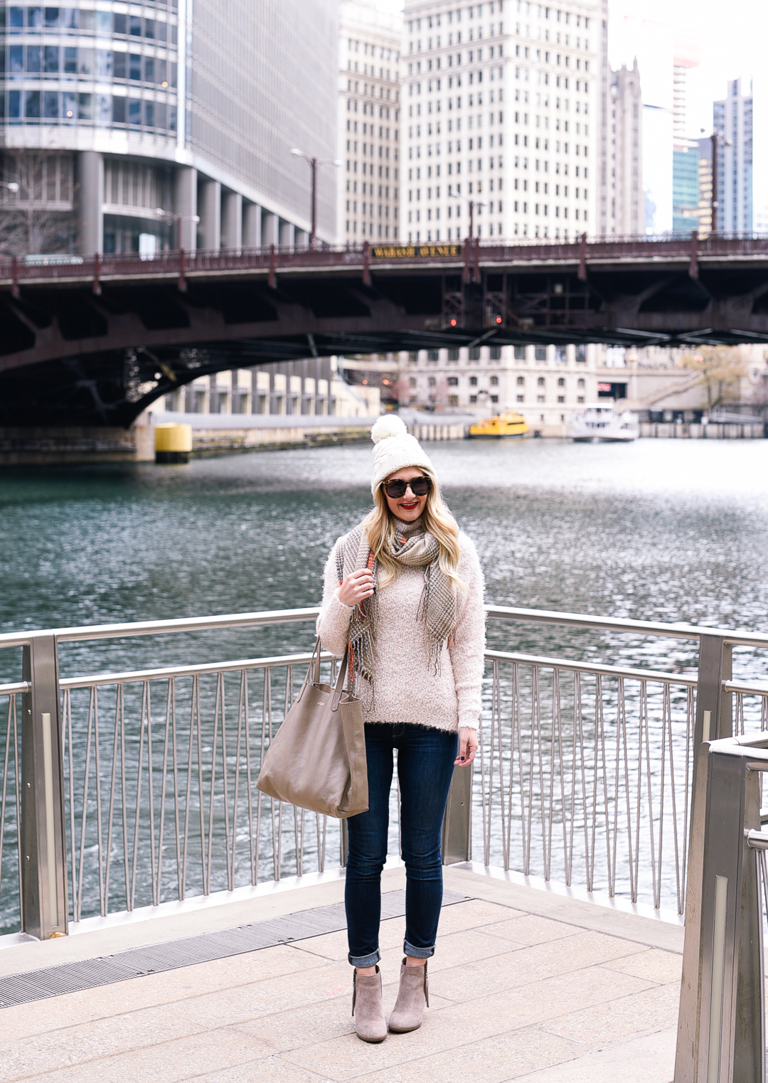 Jenna Colgrove walking along the Chicago Riverwalk in a winter outfit! 