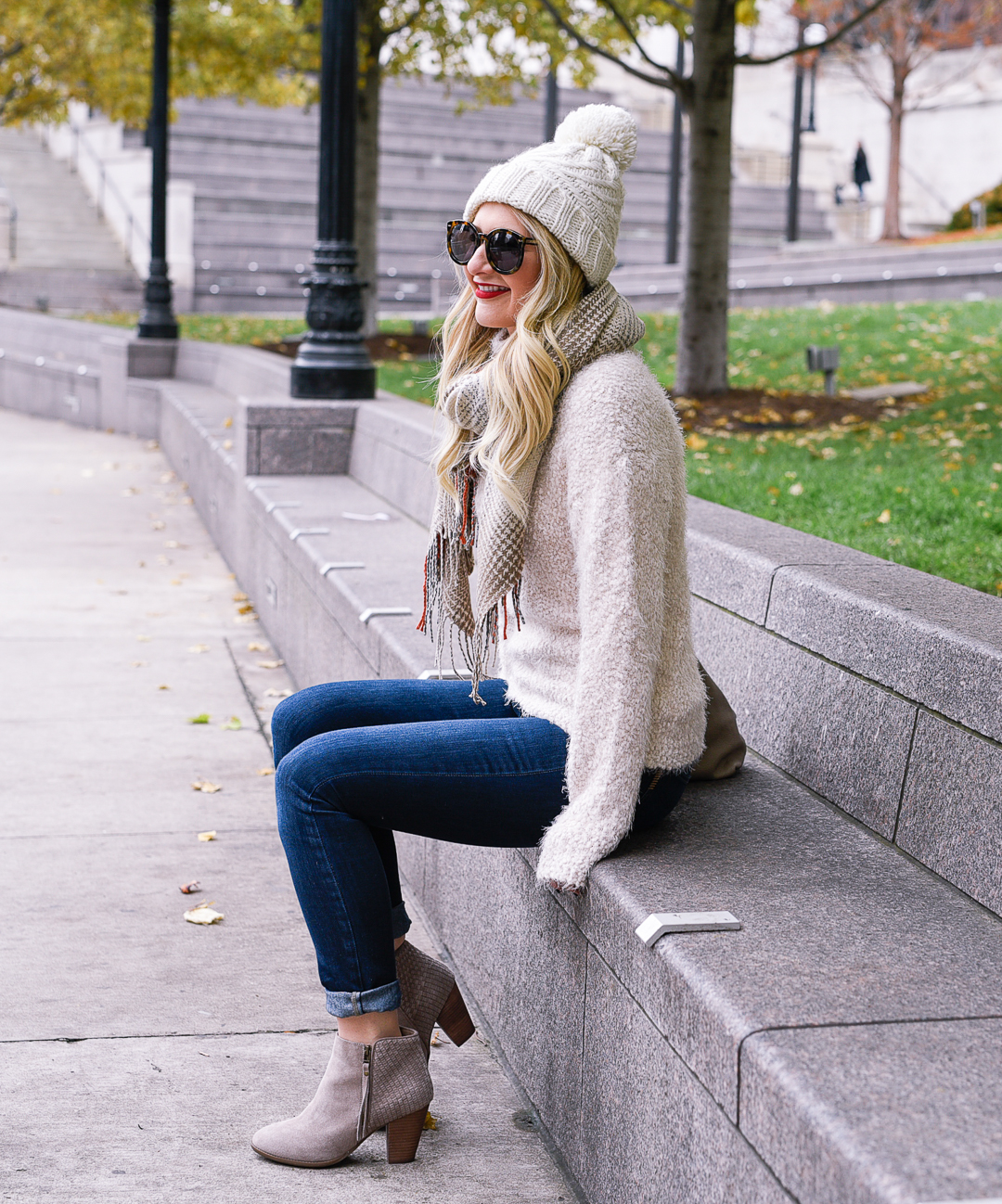 Jenna Colgrove wearing the softest white sweater, a taupe Cuyana tote, and Paige denim jeans. 