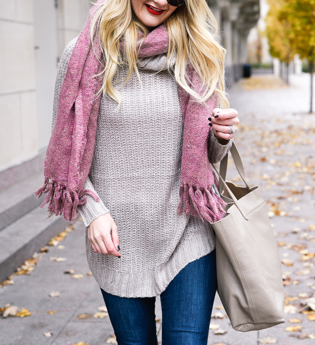 Pink Boucle scarf with fringe accesents and a knit sweater that is under $30. 