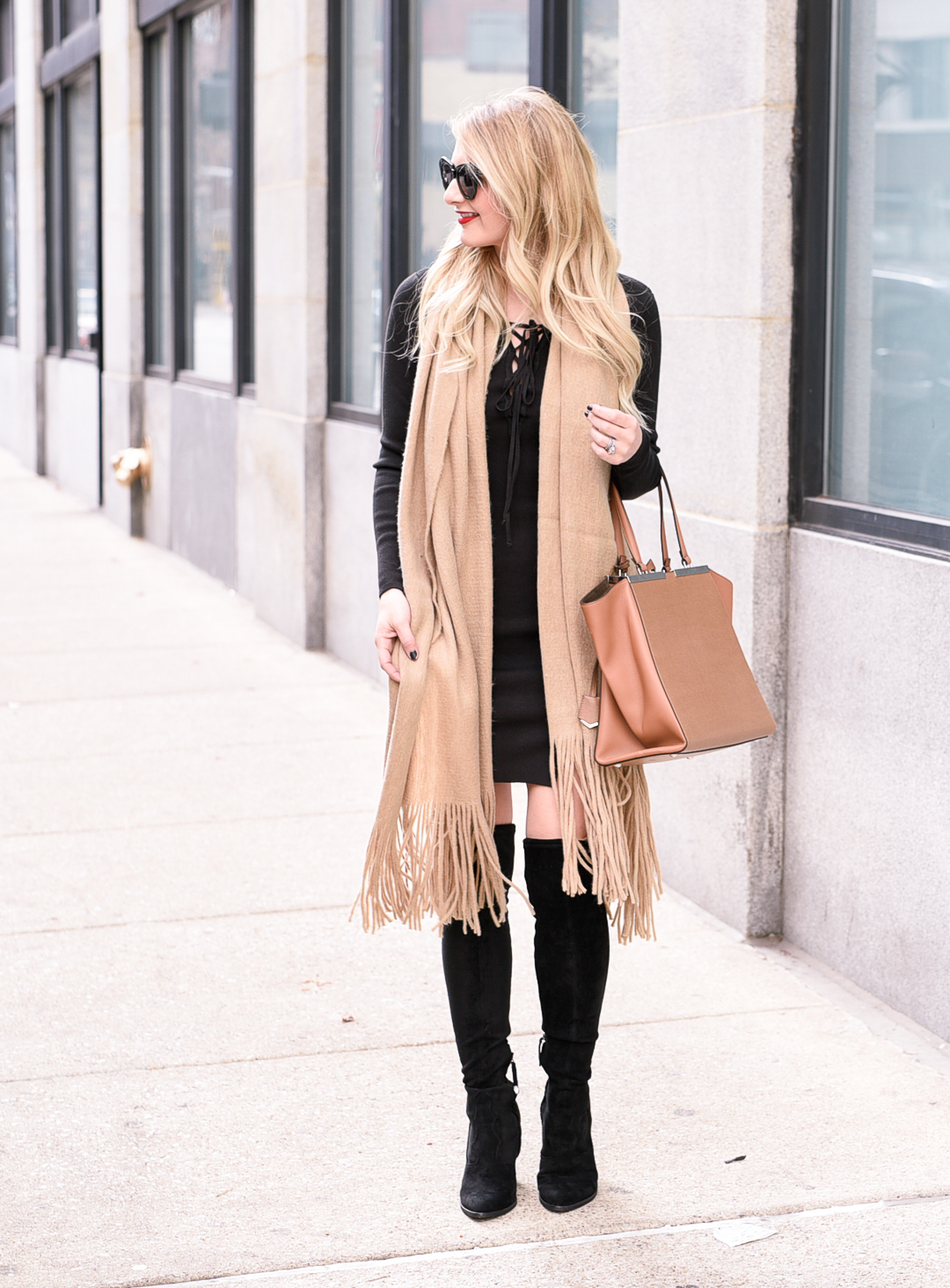 Jenna Colgrove wearing a Free People fringe scarf and a black bodycon dress.