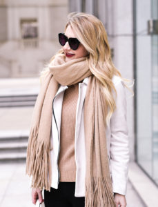 Long blonde hair and camel colored winter knits.