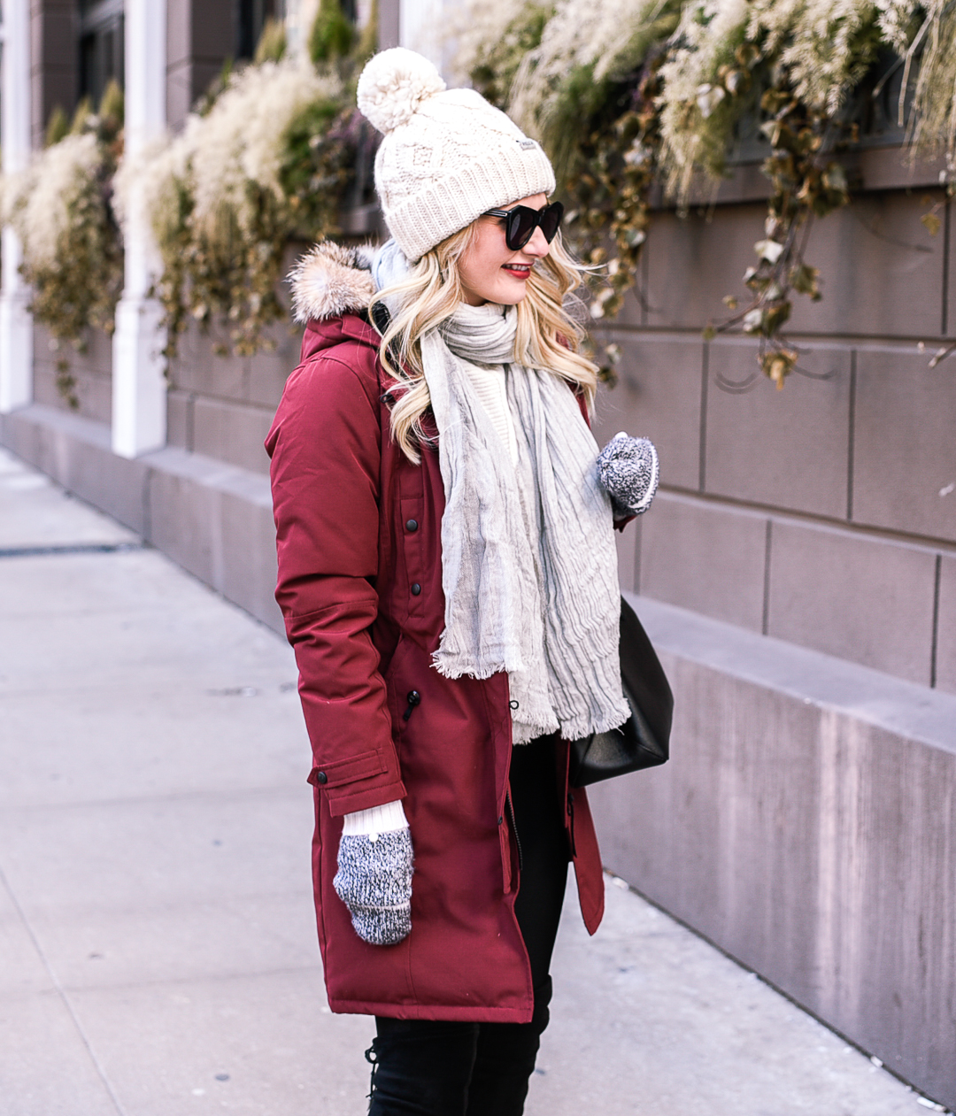 A white pom beanie with a red puffer winter coat! 