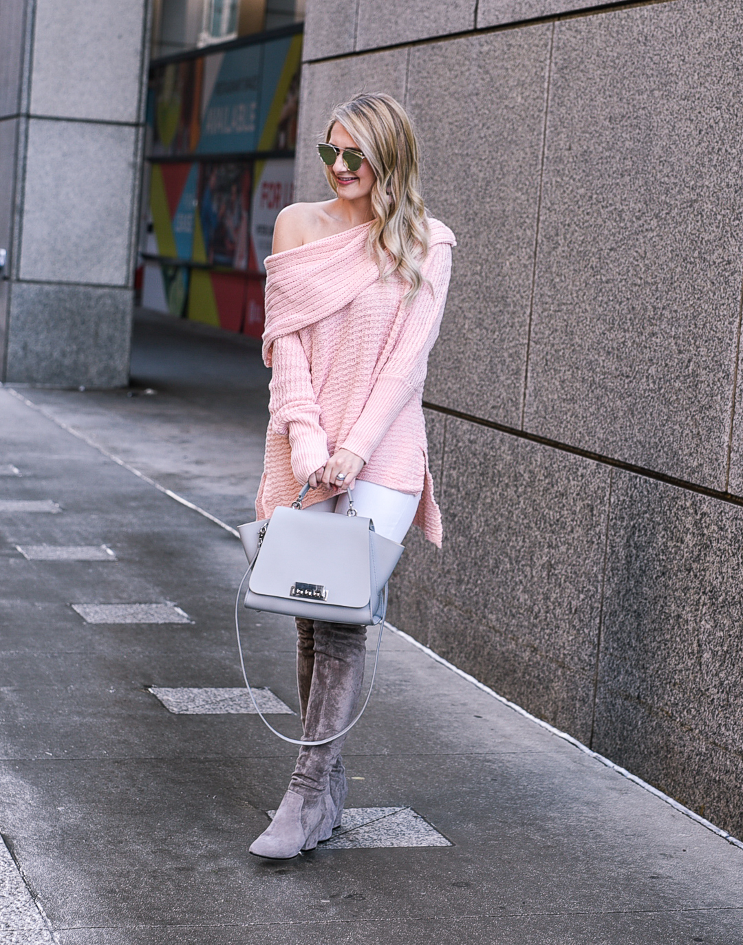 Jenna Colgrove wearing a blush off the shoulder sweater, white skinnies, and grey over the knee boots. 