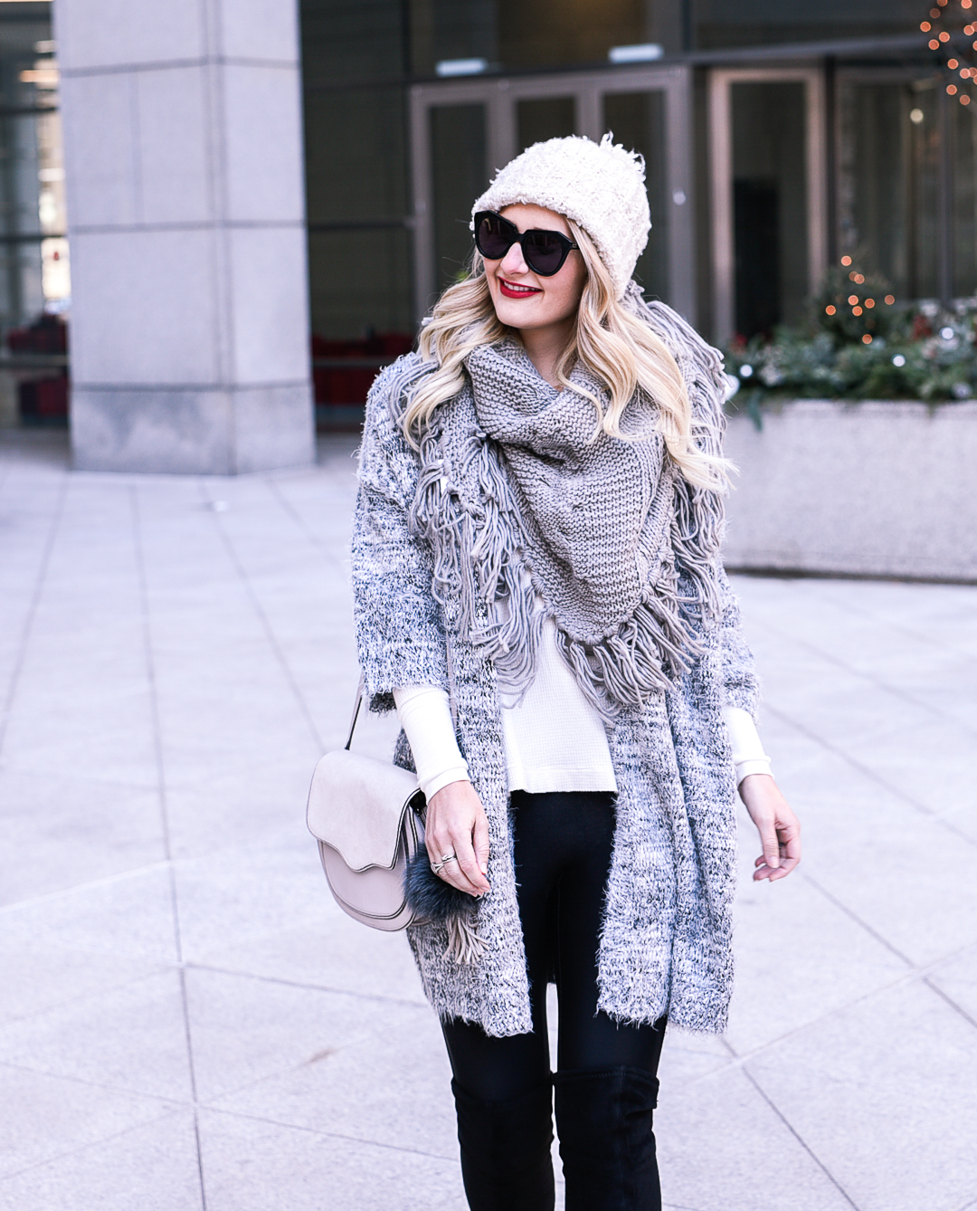 Long blonde loose curls and cozy sweater knits. 