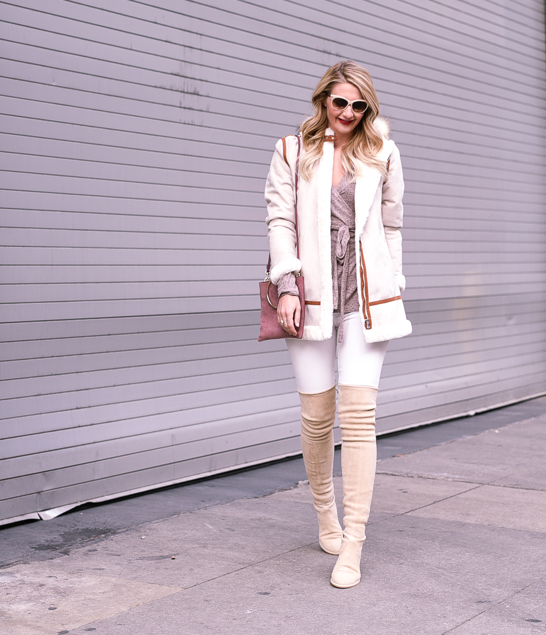 Warn winter outfit with a parka, white skinny jeans, and flattering neutral boots. 