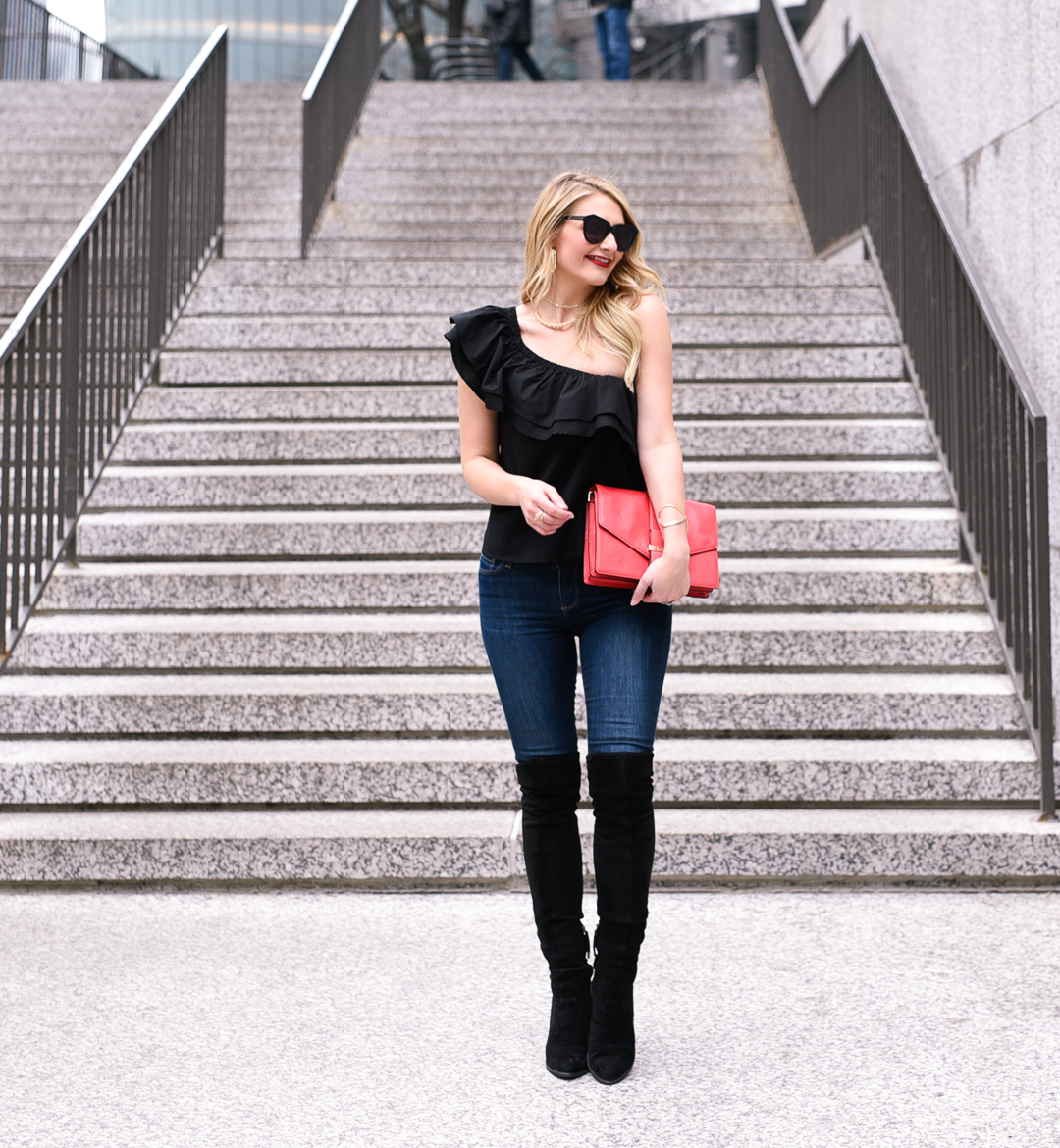 Visions of Vogue wearing a ruffled date night top and skinny jeans for Valentine's Day. 