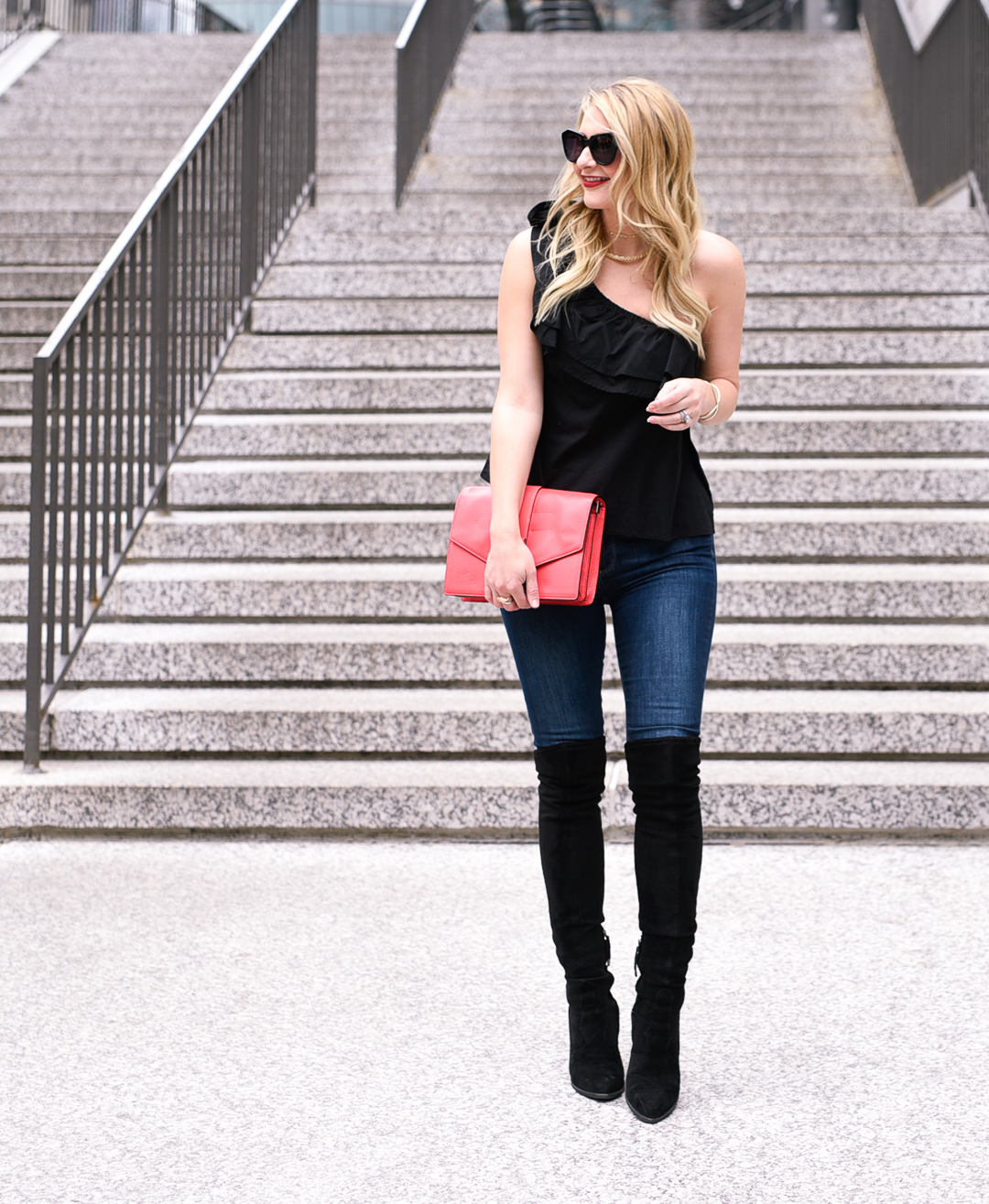 A chic and flattering outfit with a black one shoulder top and suede over the knee boots.